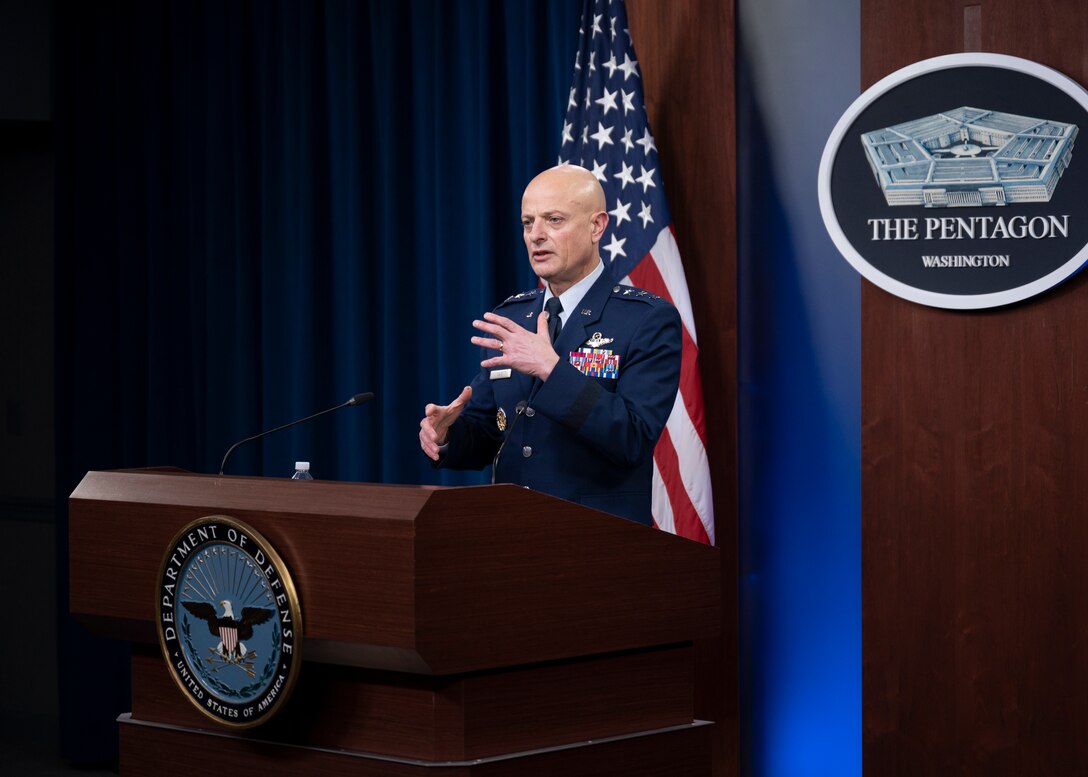 A man speaks behind a podium.