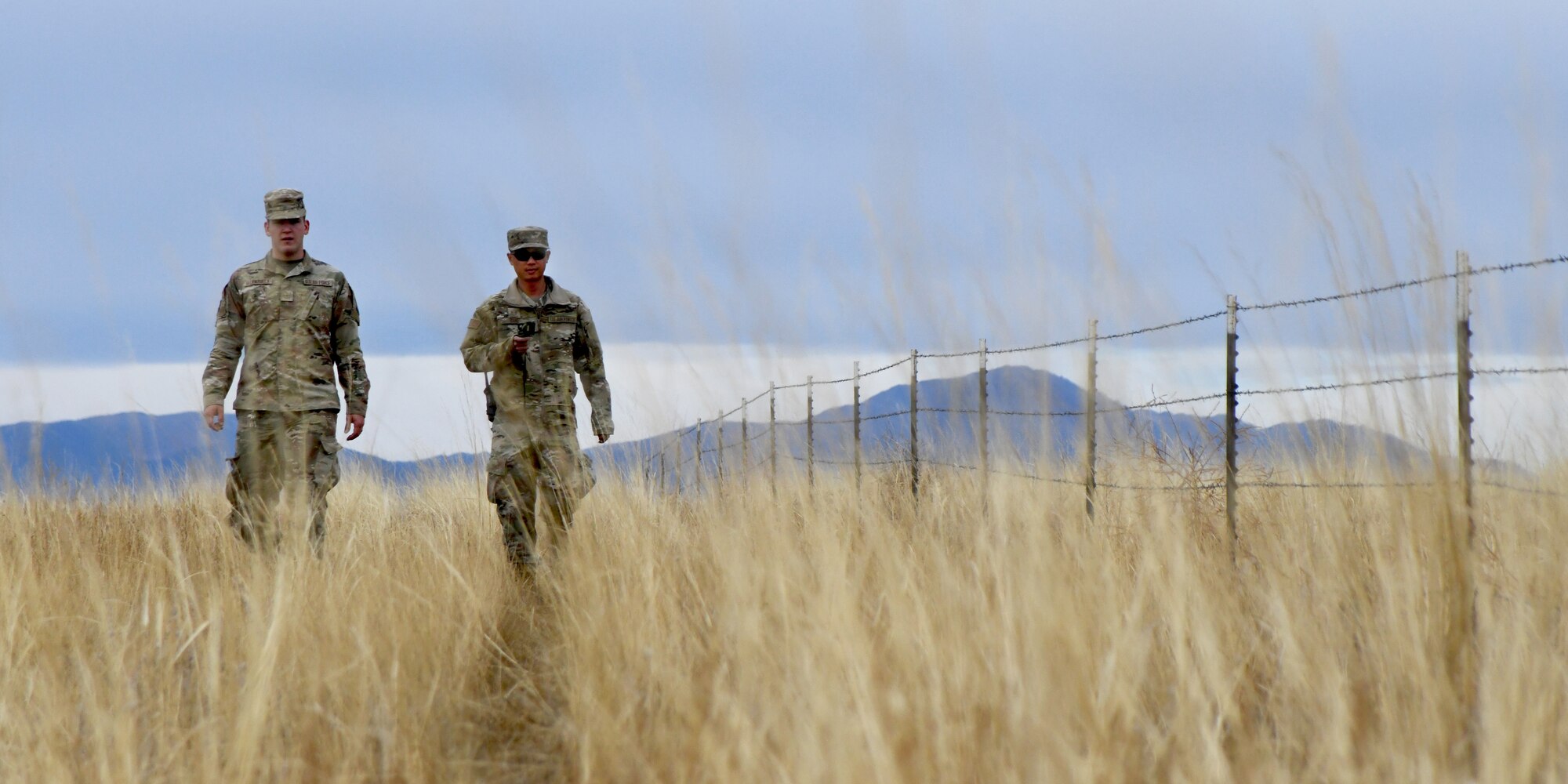 members of the 50th CES walk around practicing land navigation
