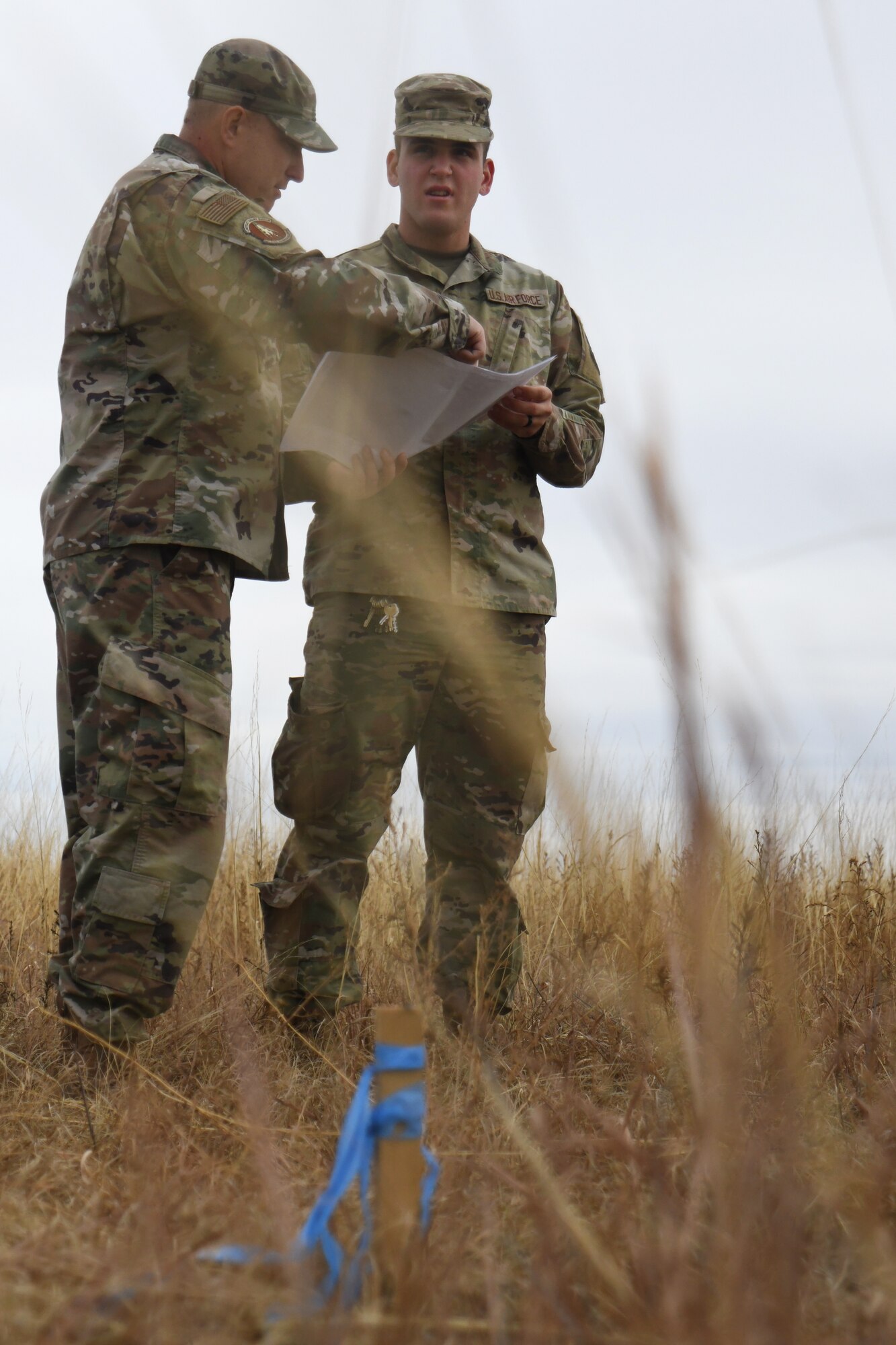 members of the 50th CES walk around practicing land navigation