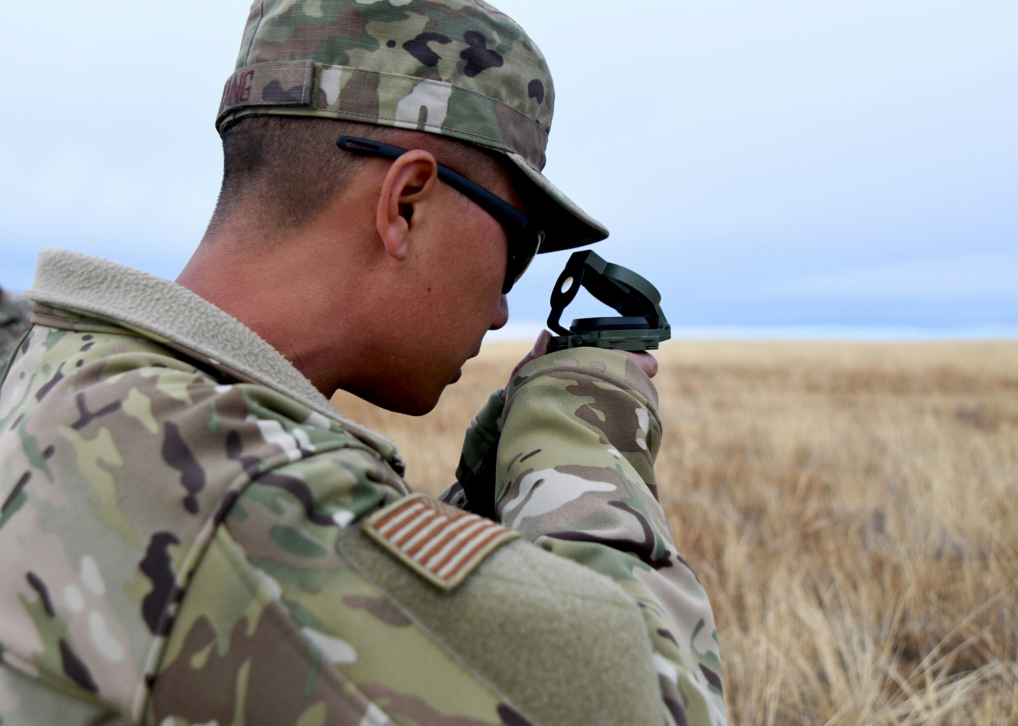 members of the 50th CES walk around practicing land navigation