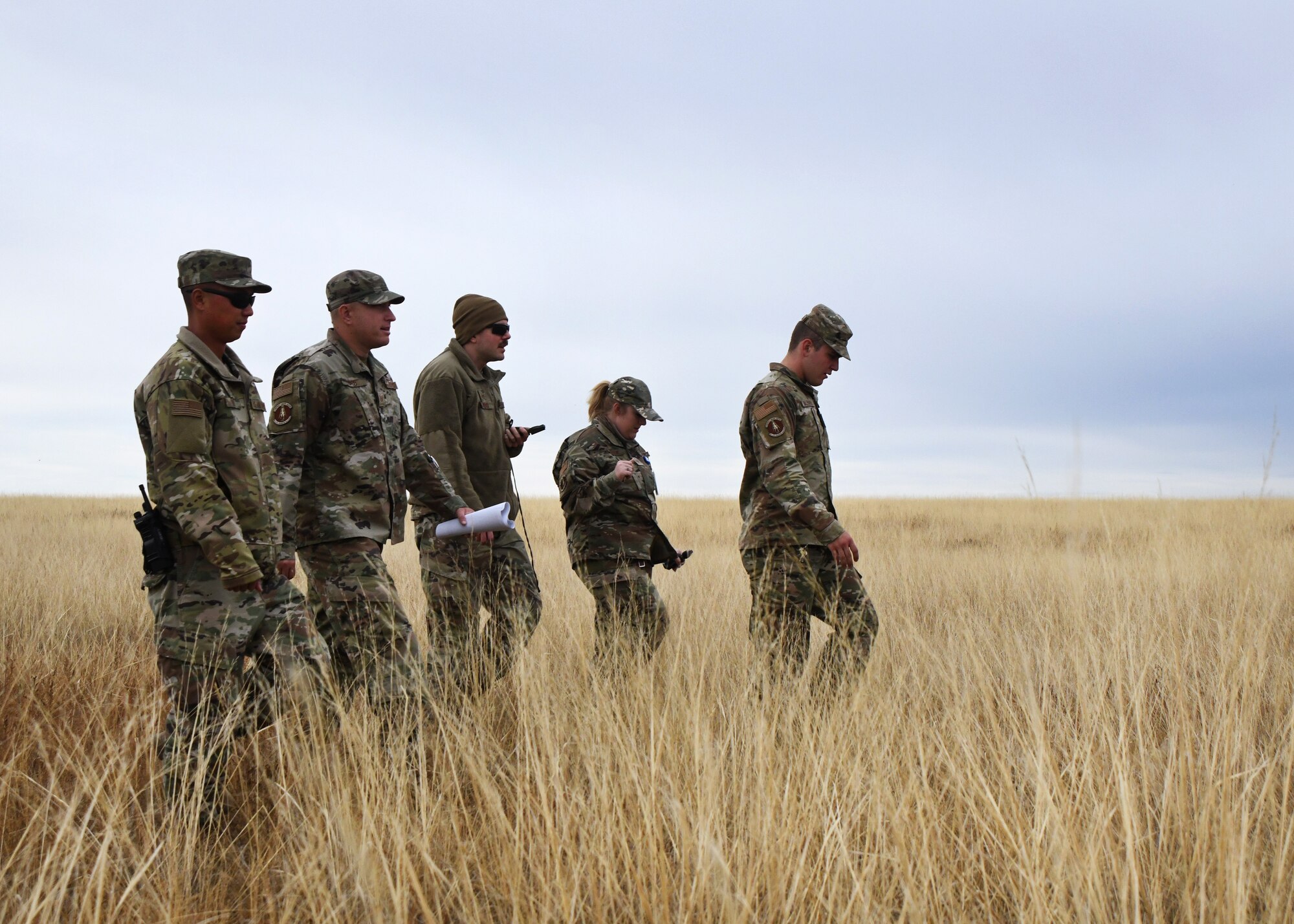 members of the 50th CES walk around practicing land navigation