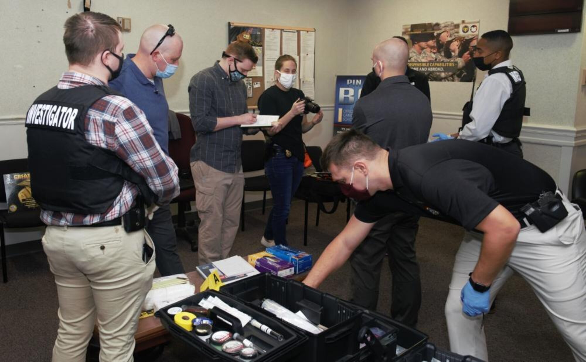 At the training staging area on Fort George G. Meade, Md., Oct. 26, 2021, Assistant Special Agent-in-Charge Jennifer Dowler, center, instructs fellow agents and interns on how to properly photograph a crime scene when first approaching the scene. (Photo by Ronna Weyland, CID)