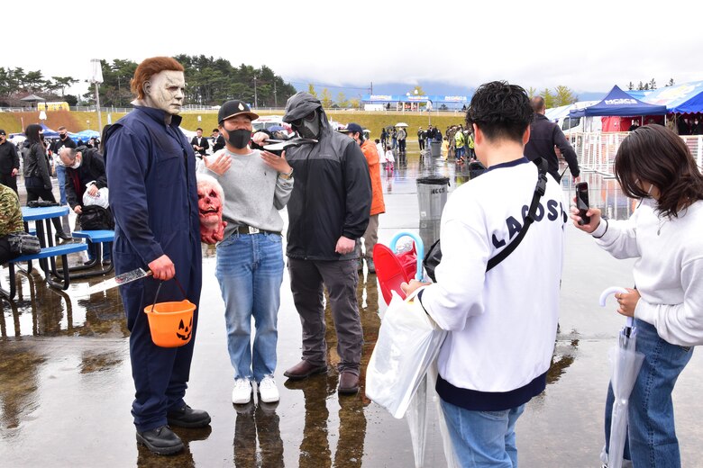 Festival attendees take photos with other costumed attendees at the Fuji Friendship Festival, Combined Arms Training Center Camp Fuji, Shizuoka, Japan, Oct. 31, 2021. Festival attendees were able to view static displays, listen to live entertainment, and interact with U.S. and Japan Self-Defense Force personnel. (U.S. Marine Corps photo by Katie Gray)
