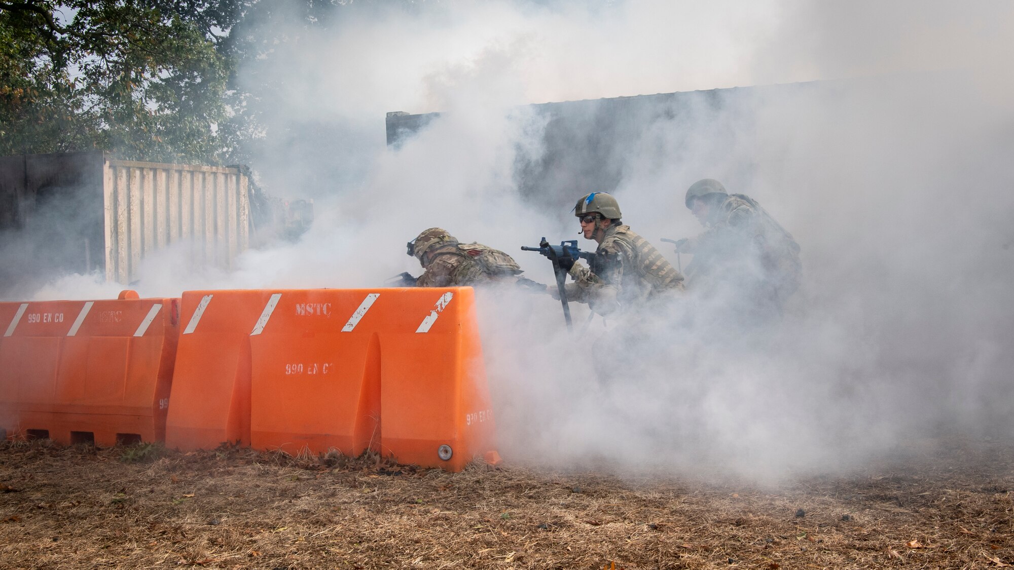 U.S. Airmen from the 514th Air Mobility Wing and the 421st Combat Training Squadron, both at Joint Base McGuire-Dix-Lakehurst, New Jersey, the 171st Air Refueling Wing, Pennsylvania, and the Office of the Surgeon General, Headquarters U.S. Air Force, Virginia, simulate taking cover during the tactical maneuvers portion of a Tactical Combat Casualty Care course at the Medical Simulation and Training Center at JB MDL, N.J., October 31, 2021. The course was designed to provide members who are not normally involved in combat environments the skills to survive and care for casualties in the event they are under attack.
