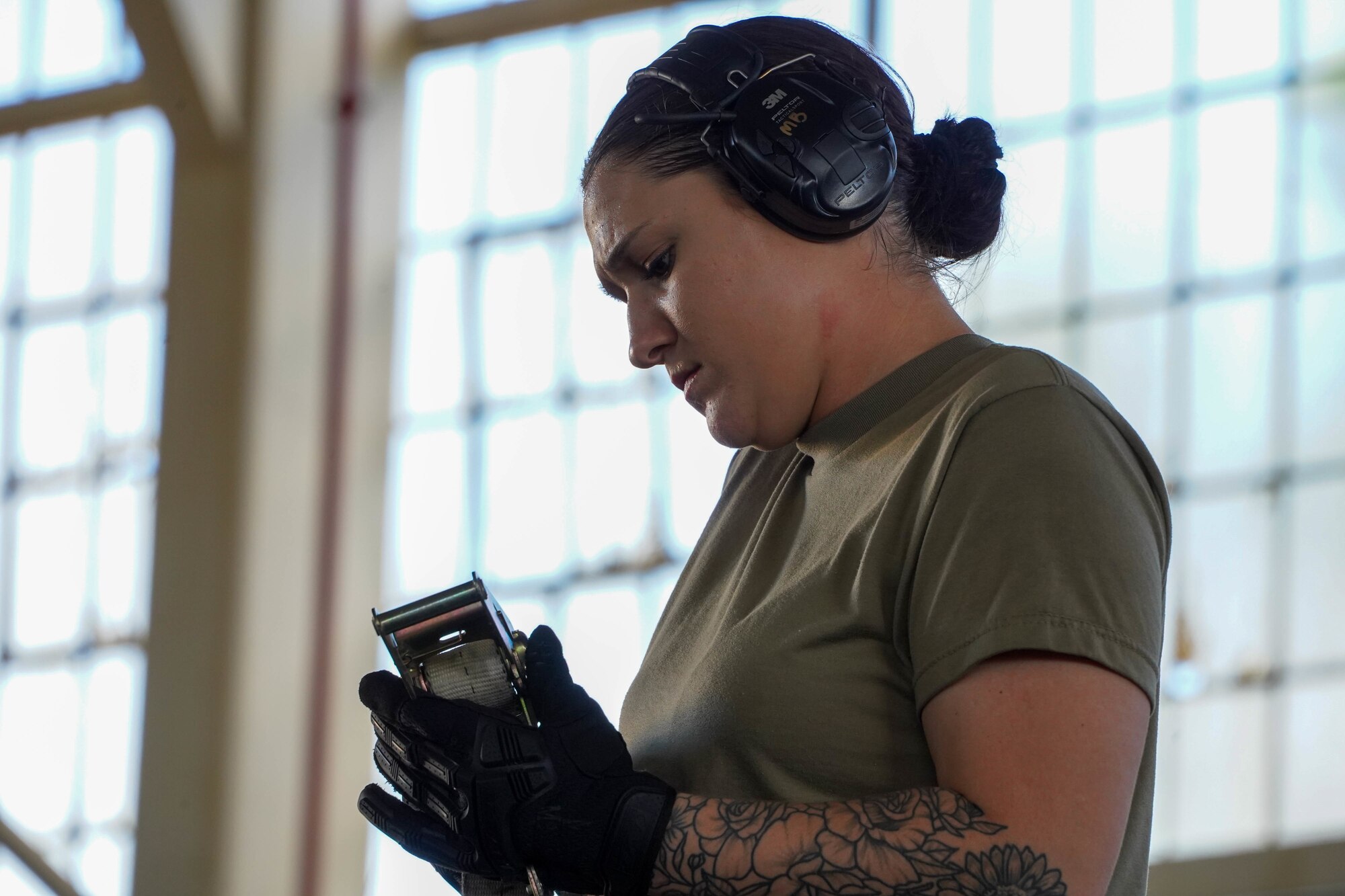 Airman 1st Class Madison Brantley, 647th Logistics Readiness Squadron combat mobility flight team member, uses a ratchet strap to secure cargo onto a K-loader trailer to support the NASA Human Space Flight Crew 2 return and Space Flight Crew 3 if needed at Joint Base Pearl Harbor-Hickam, Hawaii, Oct. 29, 2021. The 647th LRS uploaded life-saving rescue equipment to ensure it is ready at a moment’s notice to safeguard astronauts taking off and returning to Earth from the International Space Station. (U.S. Air Force photo by Airman 1st Class Makensie Cooper)