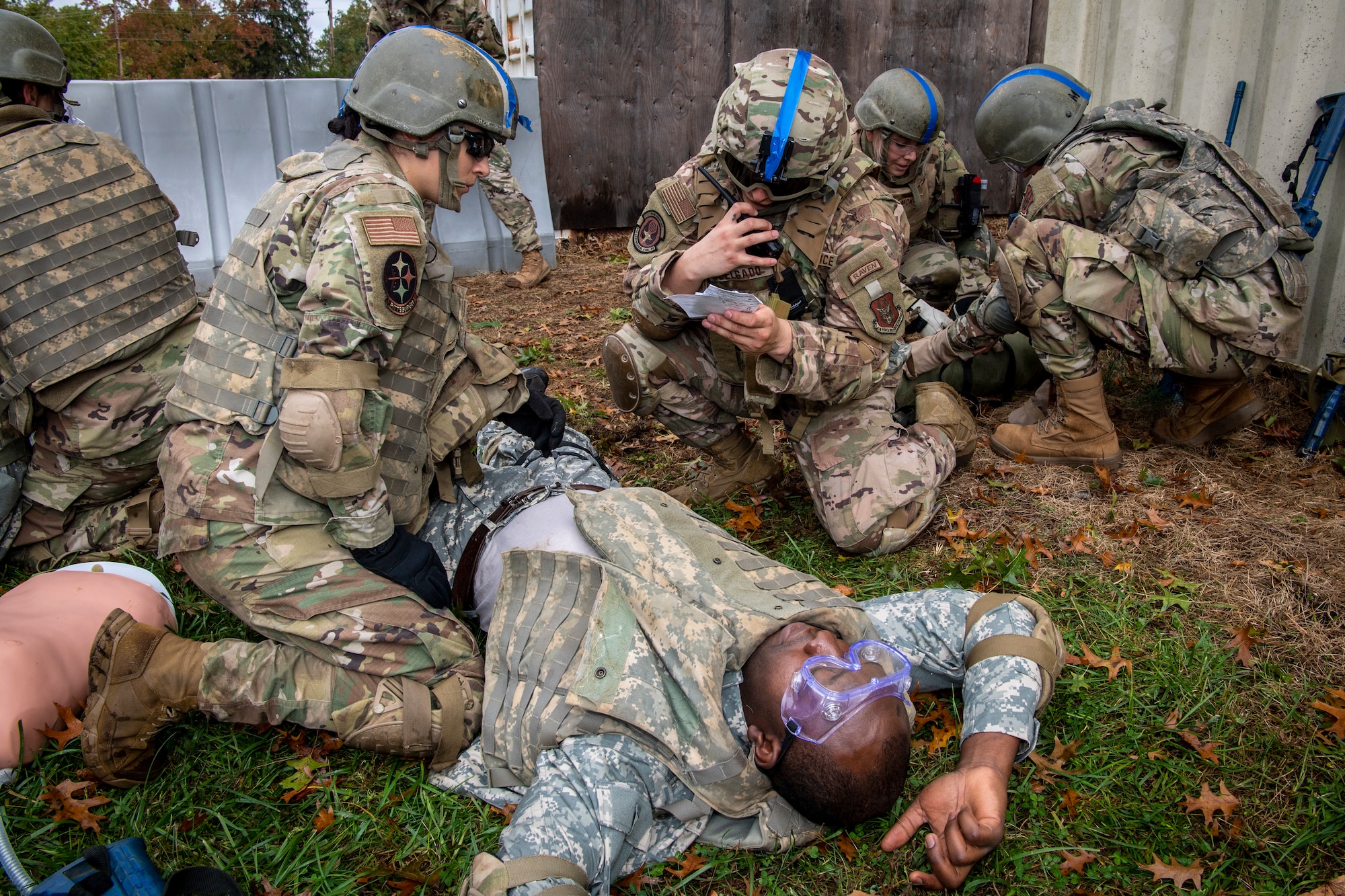 U.S. Airmen from the 514th Air Mobility Wing, Joint Base McGuire-Dix-Lakehurst, New Jersey, and the 171st Air Refueling Wing, Pennsylvania, simulate calling in a nine-line while providing patient care and transport during Tactical Combat Casualty Care training at the Medical Simulation and Training Center at JB MDL, N.J., October 31, 2021. True to the concept of Air Force Total Force Integration, reserve, guard, and active duty squadrons came together to participate in this potentially life-saving course.