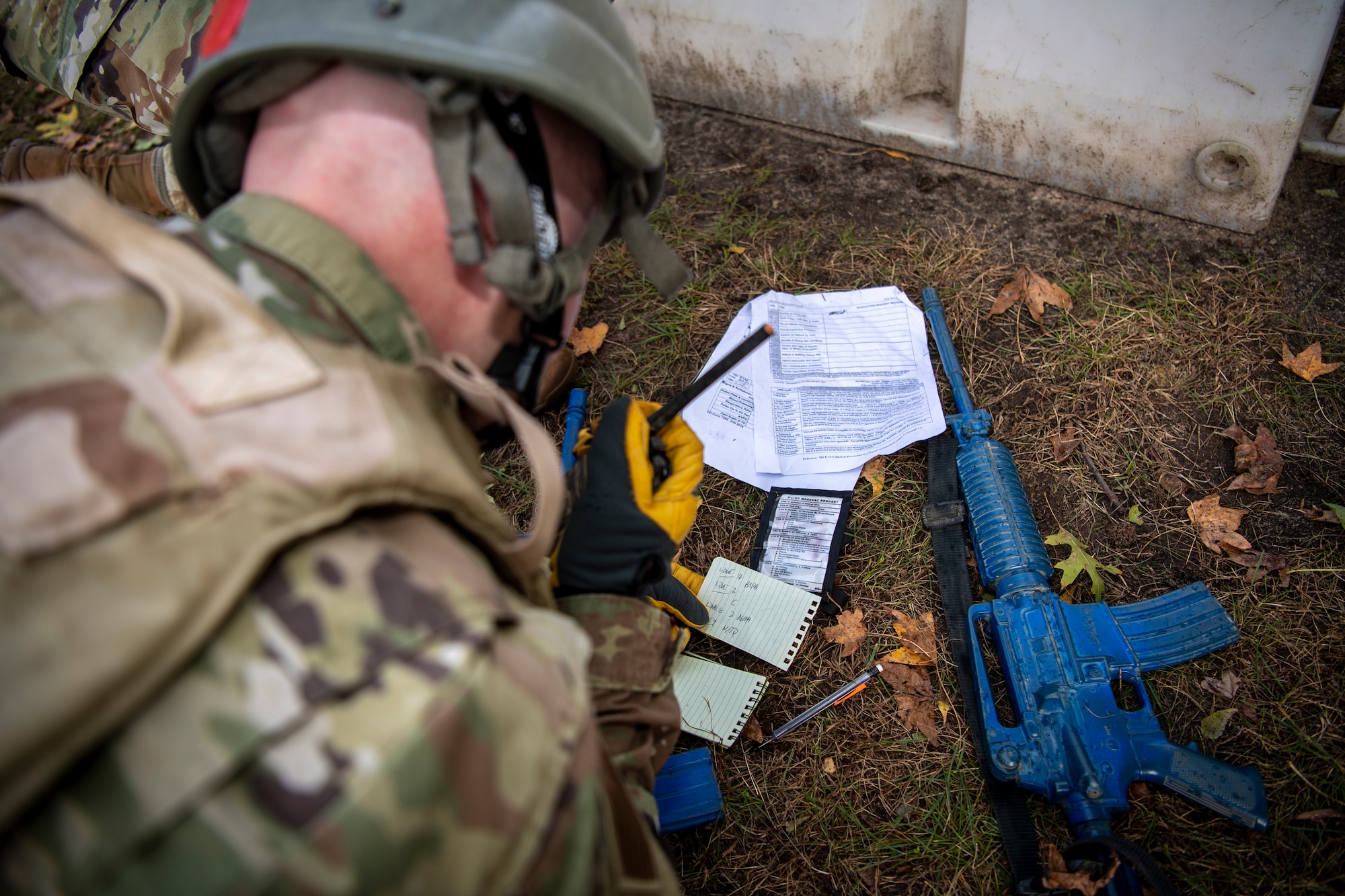 U.S. Air Force National Guardsman Staff Sgt. Matthew Kensecki, 171st Air Refueling Wing, Pennsylvania, simulates calling in a nine-line during Tactical Combat Casualty Care training at the Medical Simulation and Training Center at JB MDL, N.J., October 31, 2021. True to the concept of Air Force Total Force Integration, reserve, guard, and active duty squadrons came together to develop in this potentially life-saving course.