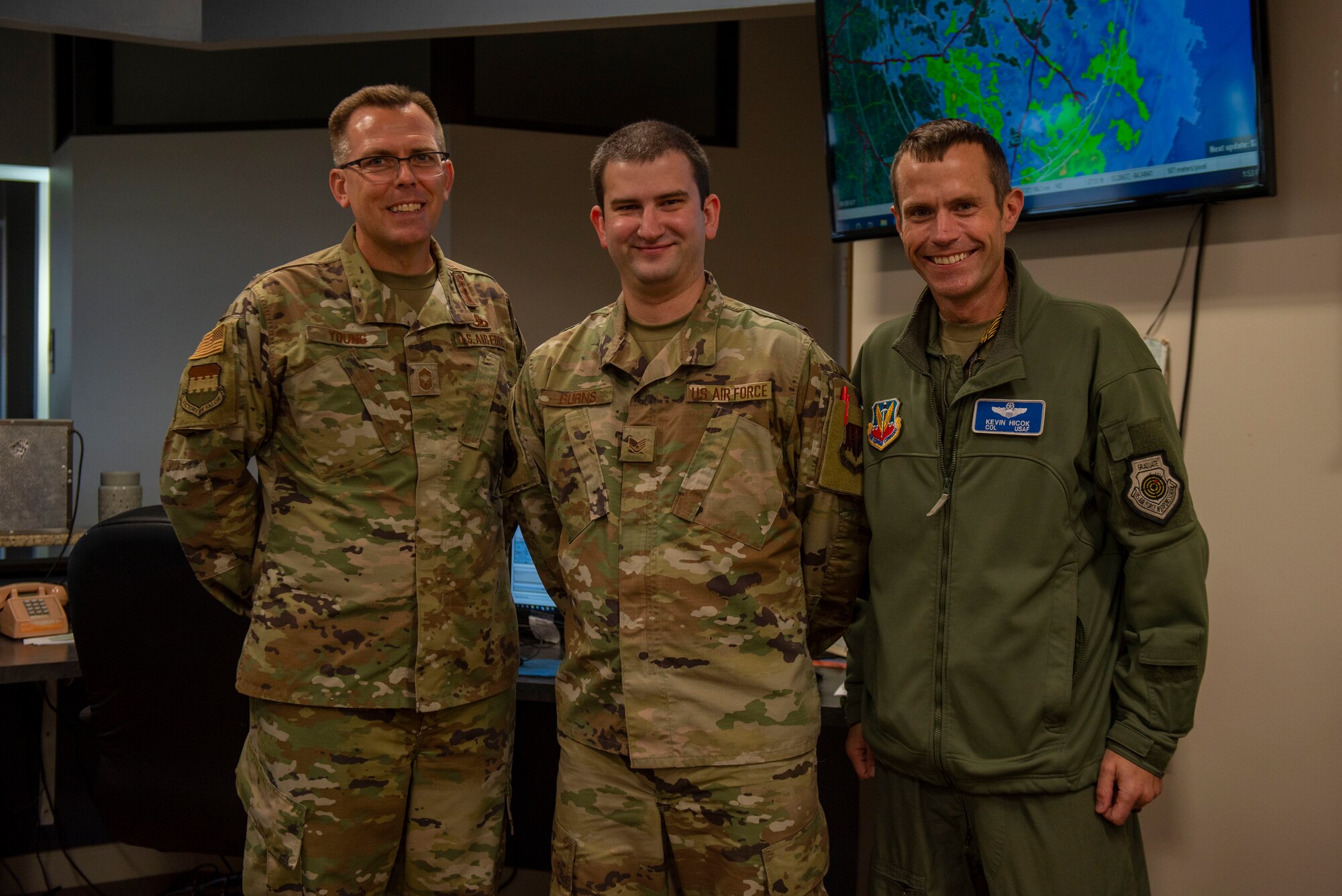 An Airman is photographed with members of their leadership.
