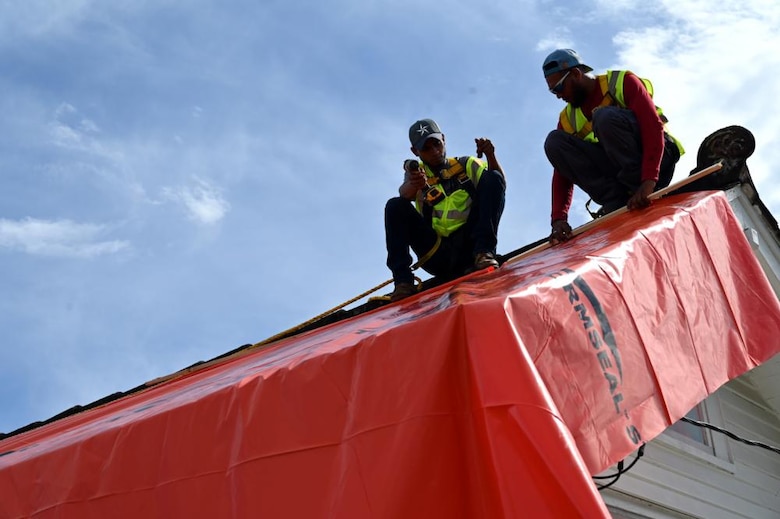 A U.S. Army Corps of Engineers contractor applies a shrinkable, plastic sheeting to a home in New Orleans that was damaged by Hurricane Ida. USACE, in cooperation with the Federal Emergency Management Agency and the state of Louisiana, recently completed a pilot program to explore temporary roofing options for homes that may otherwise have been disqualified from the USACE Operation Blue Roof program.