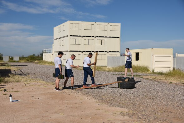 A photo of Airmen completing an obstacle course.