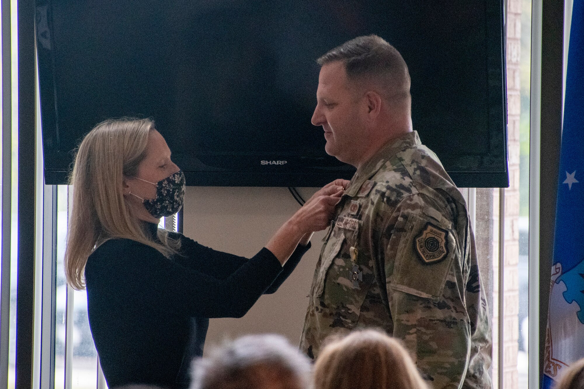 Col. Michael Belardo, 131st Maintenance Group commander, is presented with a retirement pin by his spouse during his retirement ceremony Oct. 2, 2021, in Knob Noster, Missouri. Belardo retired from the Missouri Air National Guard after many years of service. ((U.S. Air National Guard photo by Staff Sgt. Adrian Brakeley)