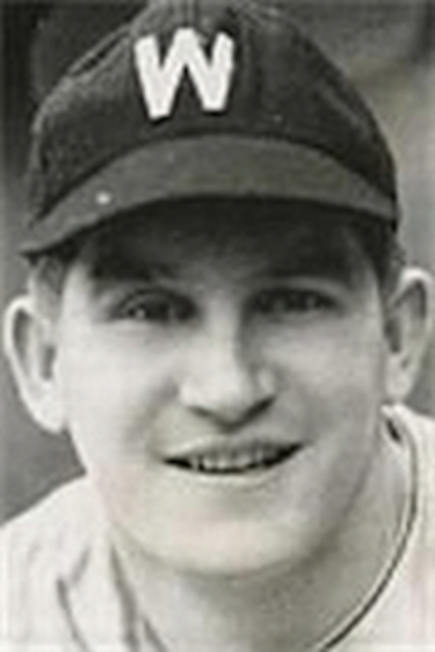 A baseball player poses for a photo.
