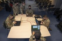 Defensive cyber network and host operators assigned to the 800th Cyber Protection Team, configure cyber weapons systems at RAF Fairford, United Kingdom, Oct. 8, 2021. U.S. Air Force cyber protection teams support and defend U.S. networks around the world to ensure mission success through strong cybersecurity posture. (U.S. Air Force photo by Senior Airman Colin Hollowell)