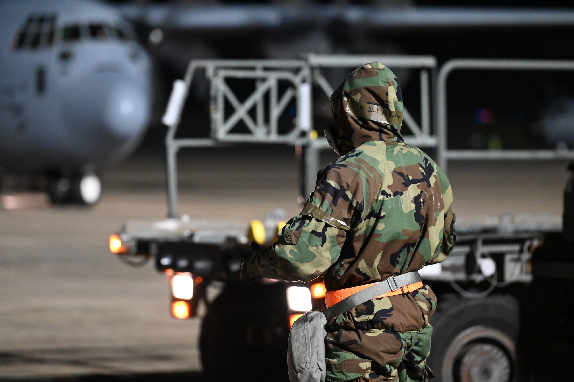 An LRS Airman prepares to offload cargo from a C-130J.