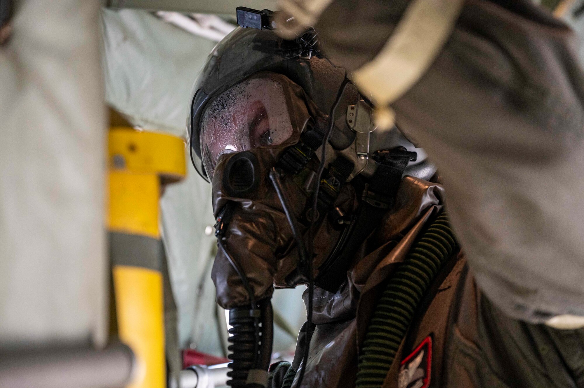 A loadmaster stands in the back of C-130J.