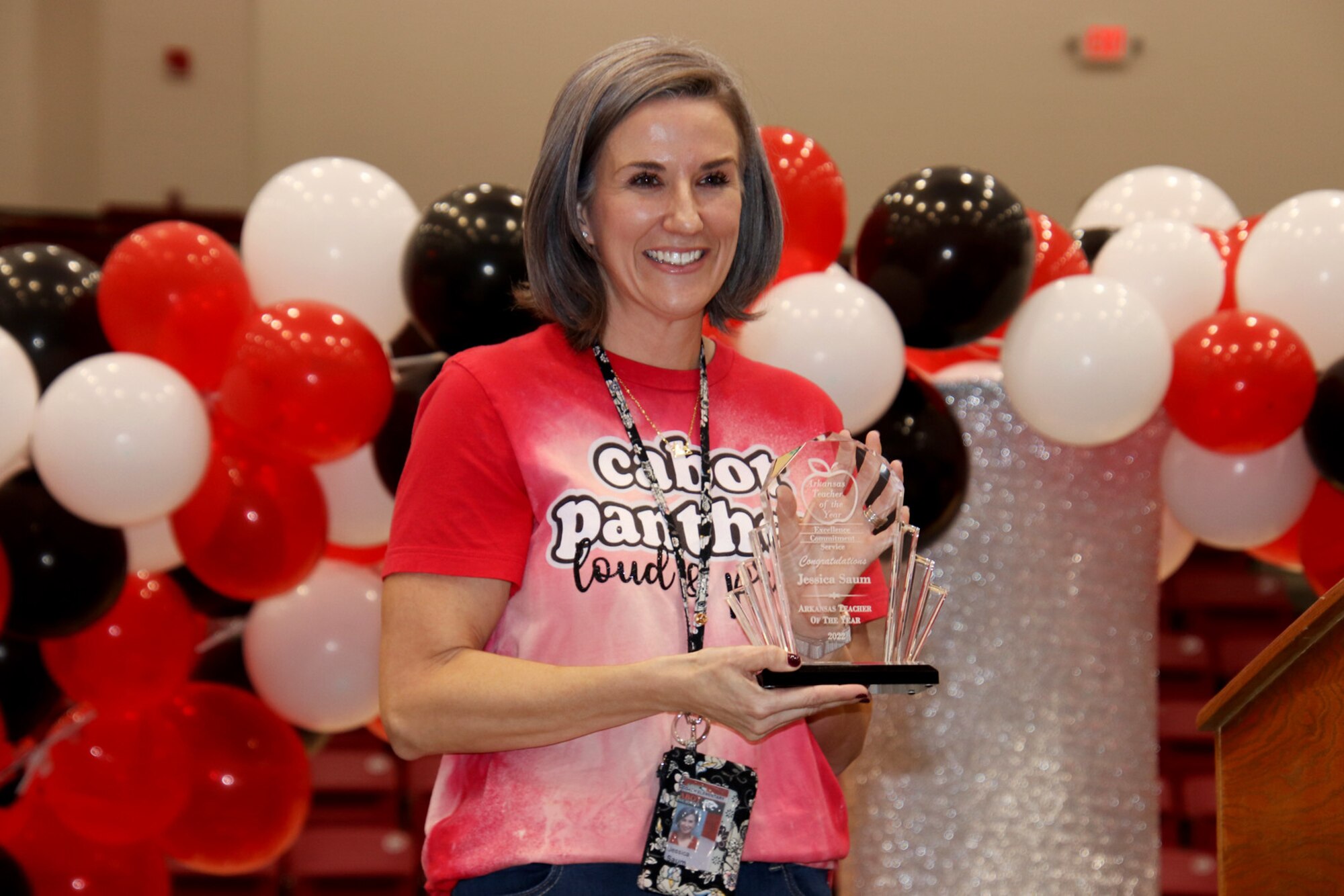 A woman poses for a photo with an award