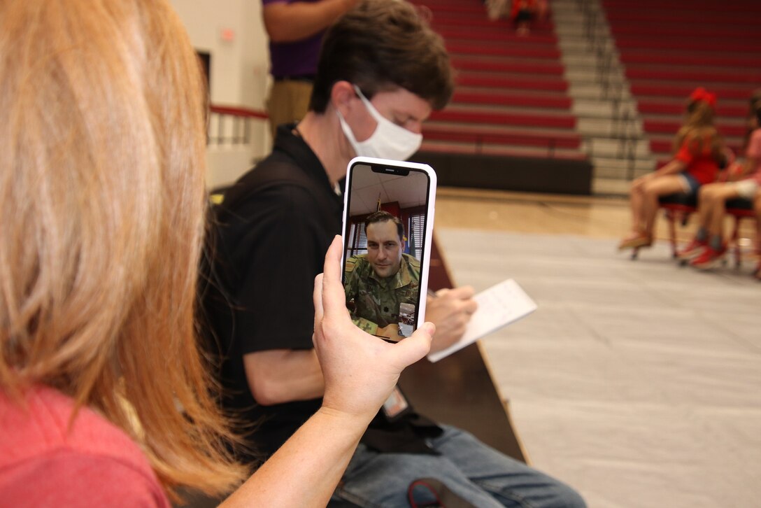 A woman views a video message