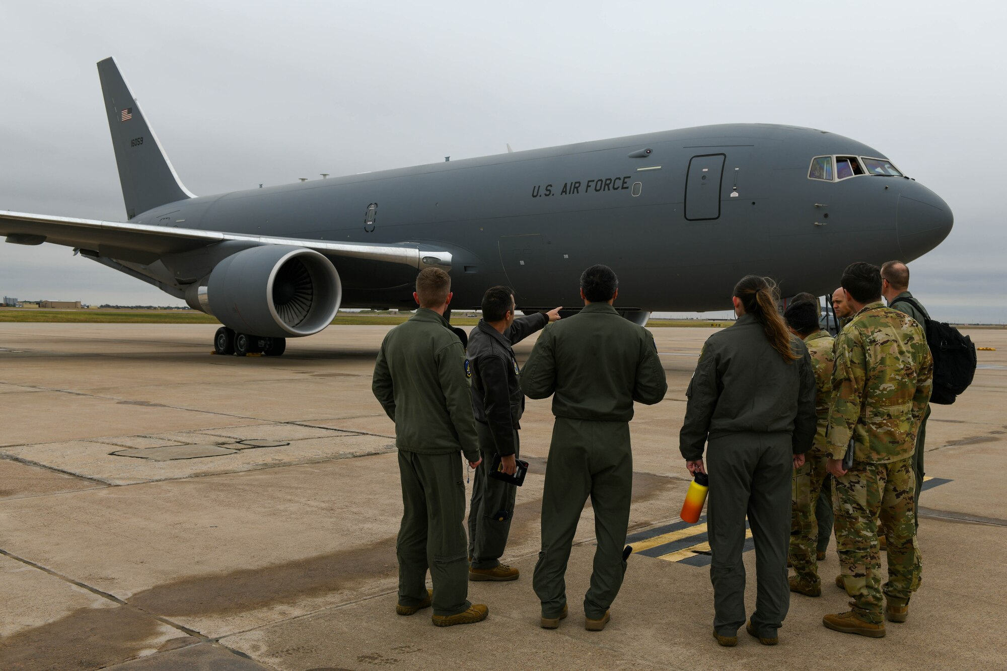 U.S. Air Force Maj. Maximilian Robidoux, 56th Air Refueling Squadron assistant director of operations, tours members of the 552nd Operations Group, from Tinker Air Force Base, Oklahoma, around a KC-46 Pegasus on Altus Air Force Base, Oklahoma, Nov. 2, 2021. The KC-46 is a refueling and strategic transport aircraft developed by Boeing from its 767 jet airliner. (U.S. Air Force photo by Airman 1st Class Trenton Jancze)