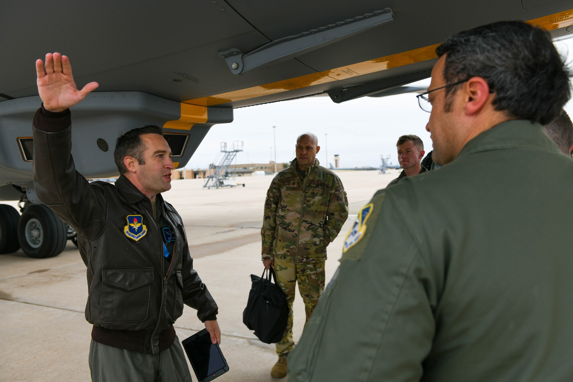 U.S. Air Force Maj. Maximilian Robidoux, 56th Air Refueling Squadron assistant director of operations, talks to members of the 552nd Operations Group (OG) about the KC-46 Pegasus on Altus Air Force Base, Oklahoma, Nov. 2, 2021. As a part of their visit, the members of the 552nd OG were shown around the KC-46 and the systems aboard the aircraft. (U.S. Air Force photo by Airman 1st Class Trenton Jancze)