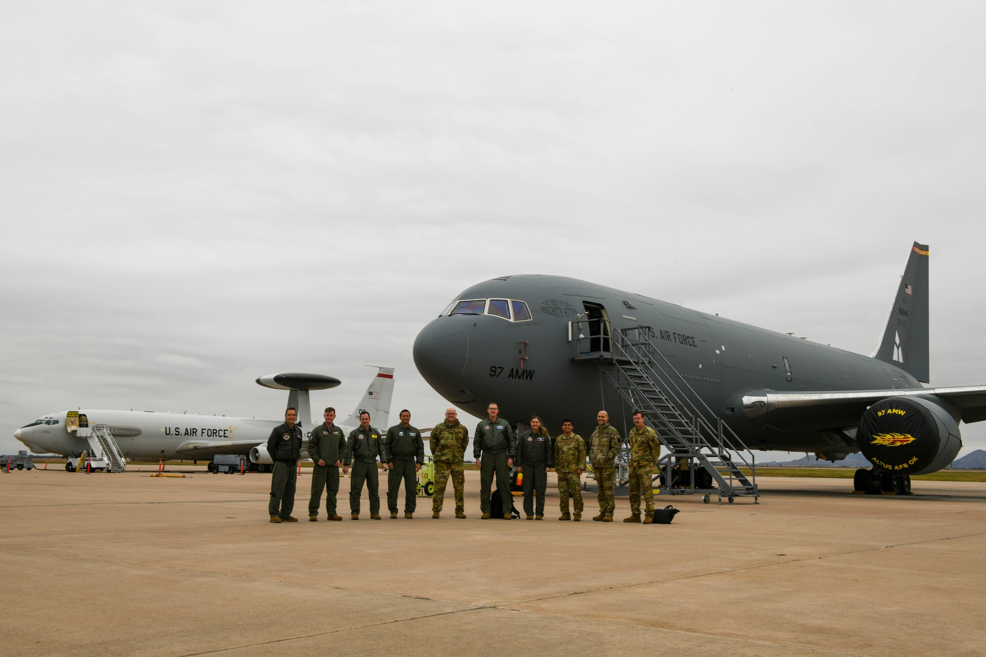 Members of the 56th Air Refueling Squadron (ARS) and the 552nd Operations Group (OG) pose for a photo on the flightline at Altus Air Force Force Base, Oklahoma, Nov. 2, 2021. The 552nd OG, from Tinker Air Force Base, Oklahoma, visited the 56th ARS to further educate them on the computer systems used on the KC-46 Pegasus. (U.S. Air Force photo by Airman 1st Class Trenton Jancze)