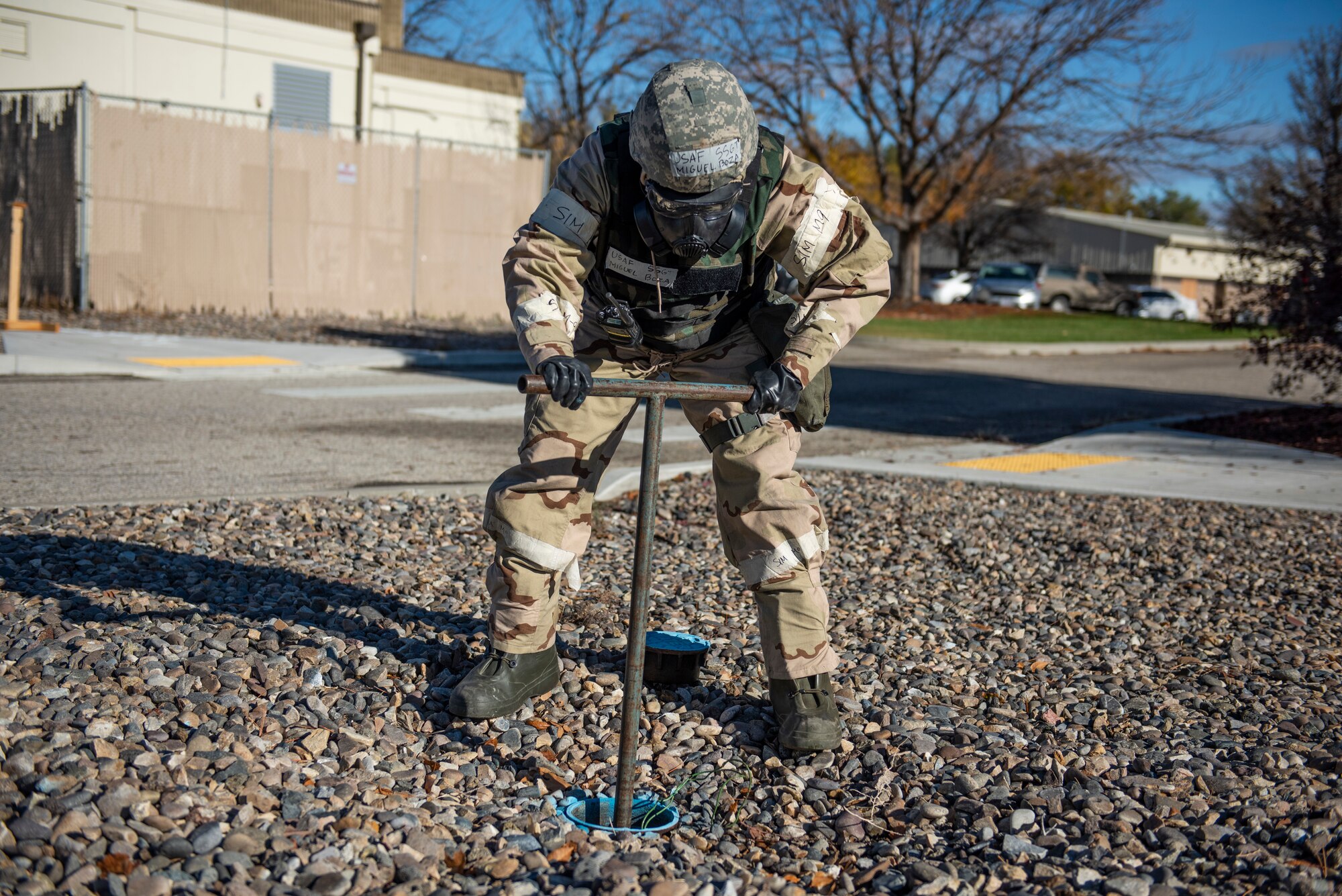 U.S. Air Force Staff Sgt. Miguel Boza, water and fuels system maintenance, 366th Civil Engineer Squadron, simulates shutting off water to a building after a simulated explosion during a Phase II exercise on Mountain Home Air Force Base, Idaho, Oct. 26, 2021. The purpose of Phase II training exercises is to test service members ability to survive and operate in a contested chemical environment.