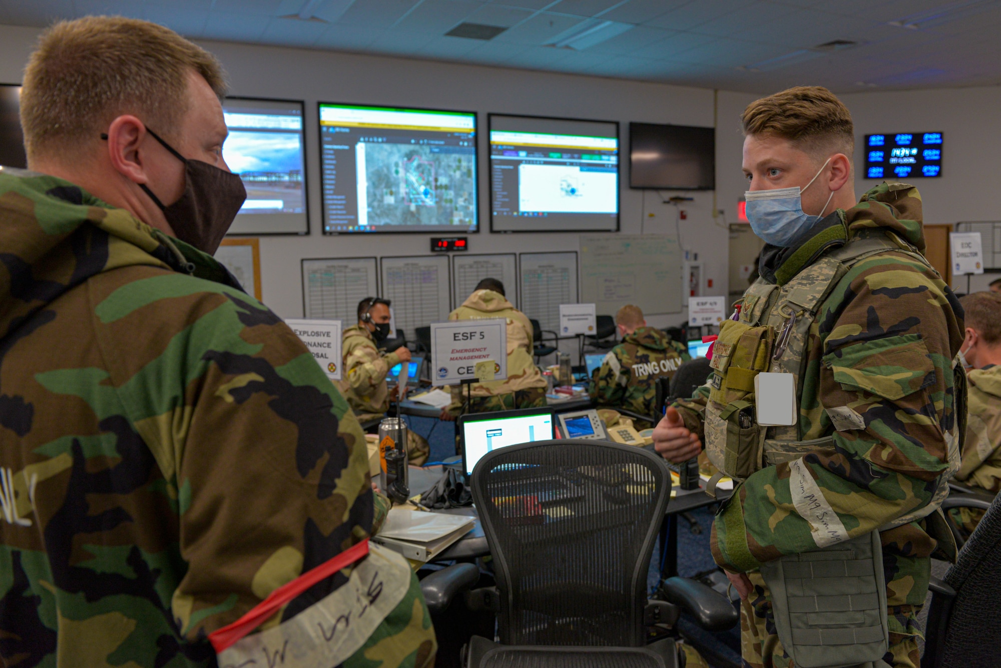 U.S. Air Force Airmen working in the Emergency Operations Center discuss processes and procedures as part of exercise Gunslinger 21-06 on Mountain Home Air Force Base, Oct. 26 2021. The Phase II exercise demonstrates the wing’s ability to survive and operate in a contested chemical environment.