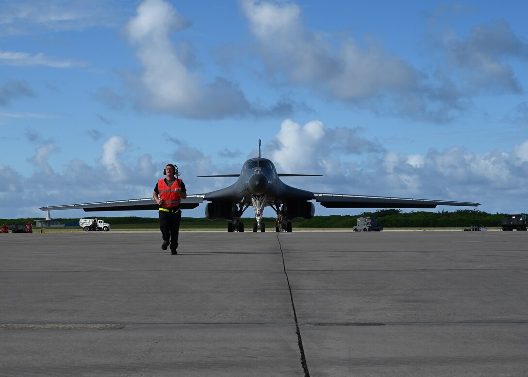 Photo of crew chief running on flightline