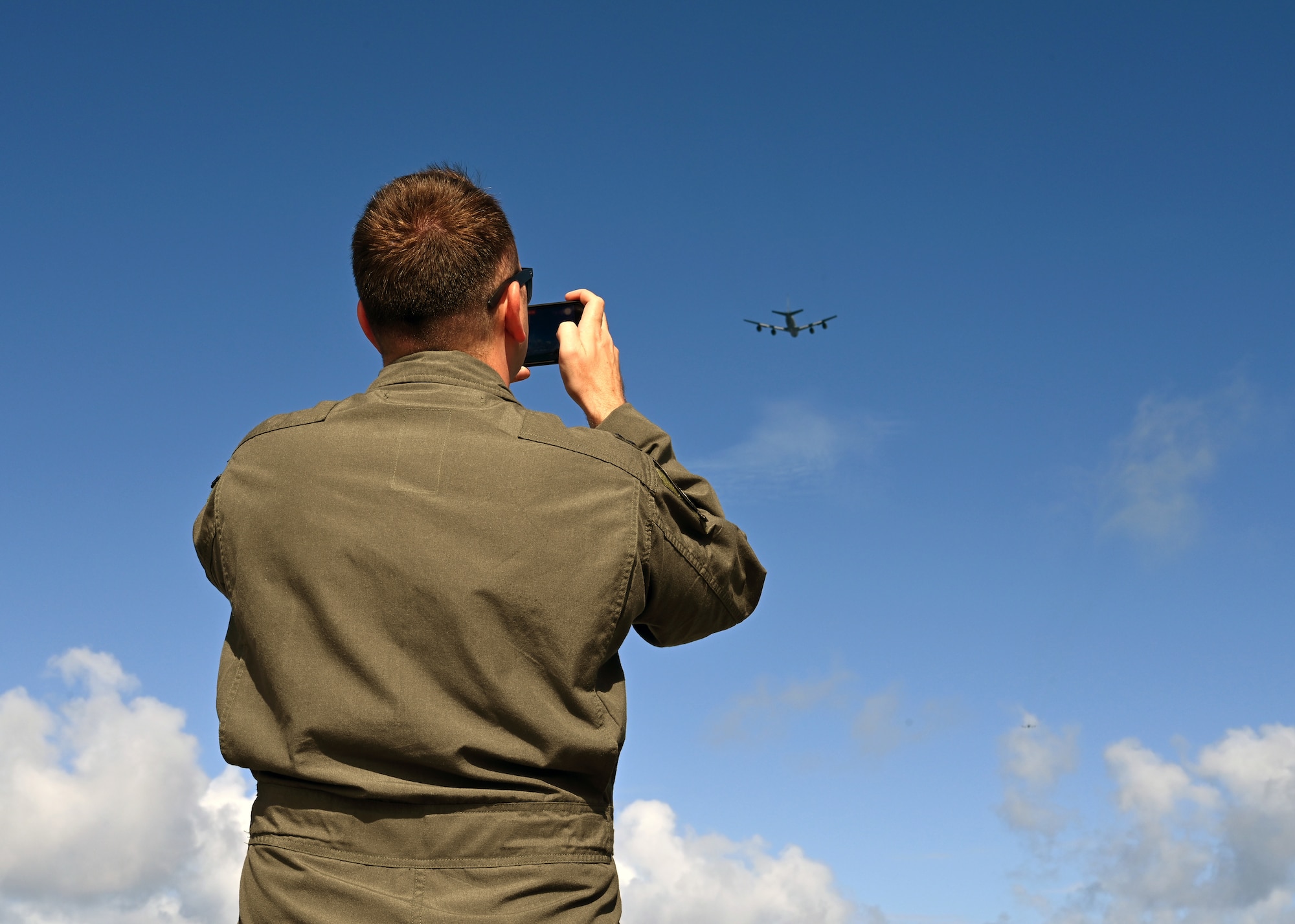 Photo of a person photographing an aircraft.