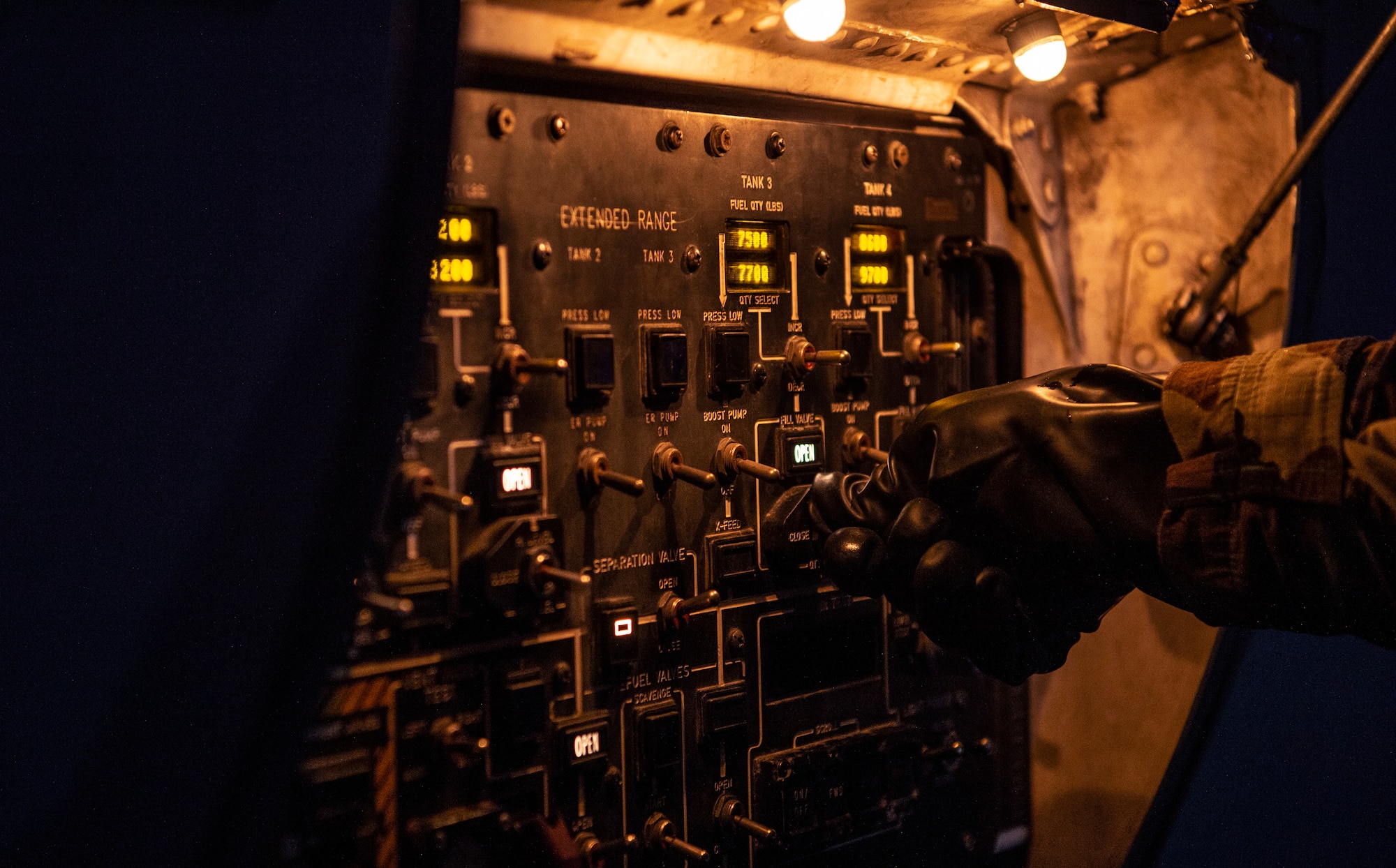 U.S. Air Force Senior Airman James Reed, 62nd Aircraft Maintenance Squadron maintainer,   adjusts a switch while refueling a C-17 Globemaster III during Exercise Rainier War 21B at Joint Base Lewis-McChord, Washington, Nov. 3, 2021. Rainier War 21B exercises and evaluates the wing’s ability to employ the force and their ability to perform during wartime and/or contingency taskings in a high-intensity, wartime contested, degraded and operationally limited environment while supporting the contingency operations against a near-peer adversary in the U.S. Indo-Pacific Command area of responsibility. (U.S. Air Force photo by Staff Sgt. Tryphena Mayhugh)