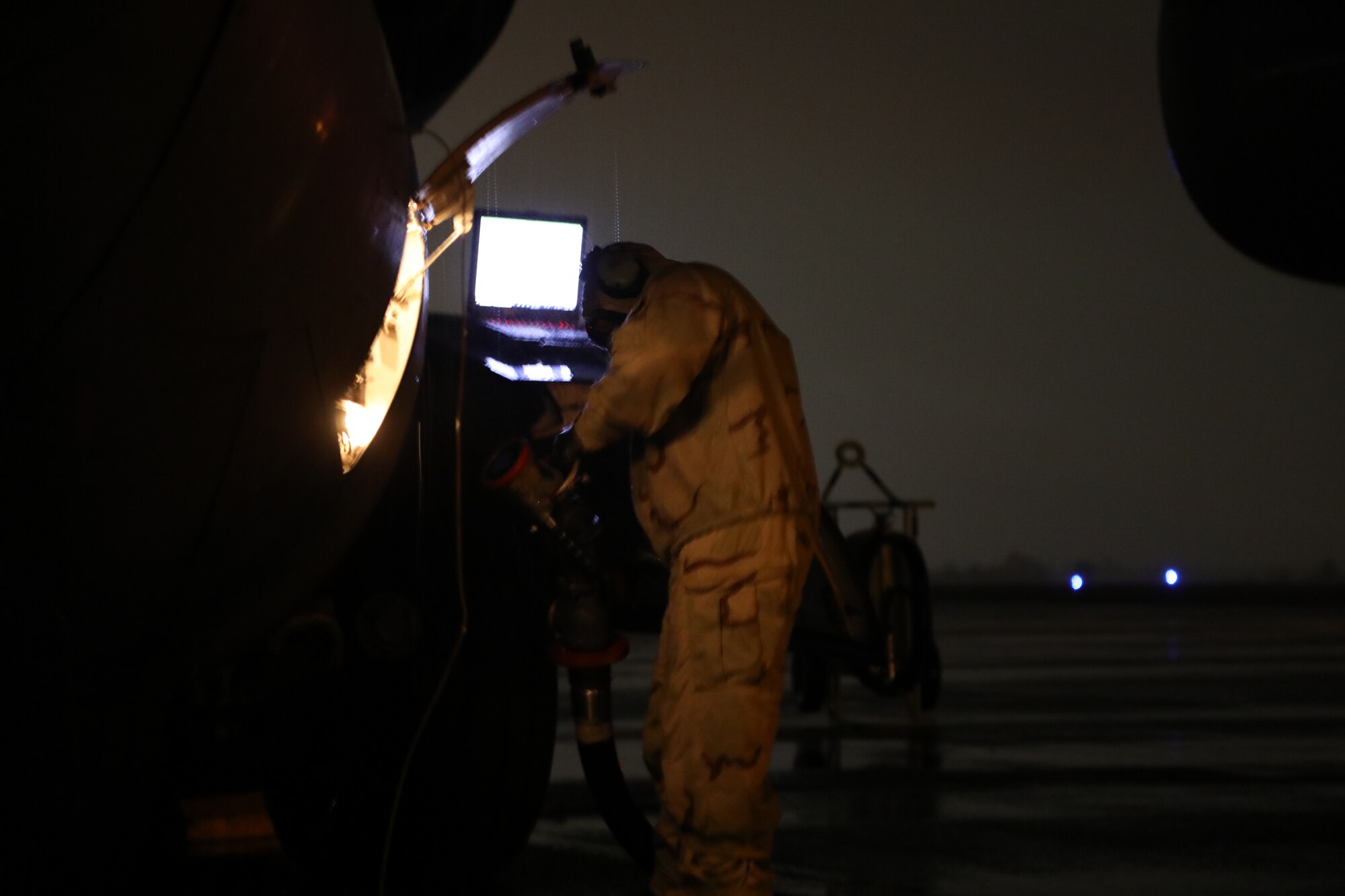 U.S. Air Force Staff Sgt. Jose Chirino, 62nd Aircraft Maintenance Squadron crew chief, attaches fuel hose for refueling to a C-17 Globemaster III while under simulated chemical, biological, radiological and nuclear conditions during Exercise Rainier War 21B at Joint Base Lewis-McChord, Washington, Nov. 3, 2021. The exercise is designed to demonstrate the wing’s ability to operate and survive while defeating challenges to the U.S. military advantage in all operating domains – air, land, sea and cyberspace. (U.S. Air Force photo by Senior Airman Christopher Sommers)