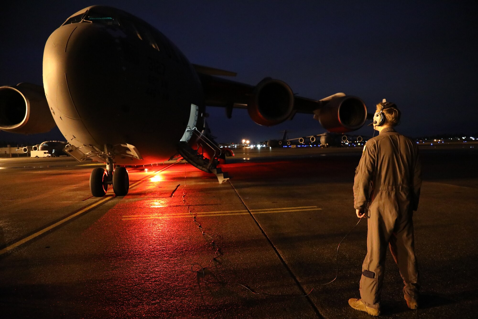 U.S. Air Force Senior Airman Jacob Kyle, 7th Airlift Squadron loadmaster, performs outside aircraft pre-flight checks on a C-17 Globemaster III during Exercise Rainier War 21B at Joint Base Lewis-McChord, Washington, Nov. 3, 2021. The exercise is designed to demonstrate the wing’s ability to operate and survive while defeating challenges to the U.S. military advantage in all operating domains – air, land, sea and cyberspace. (U.S. Air Force photo by Senior Airman Christopher Sommers)