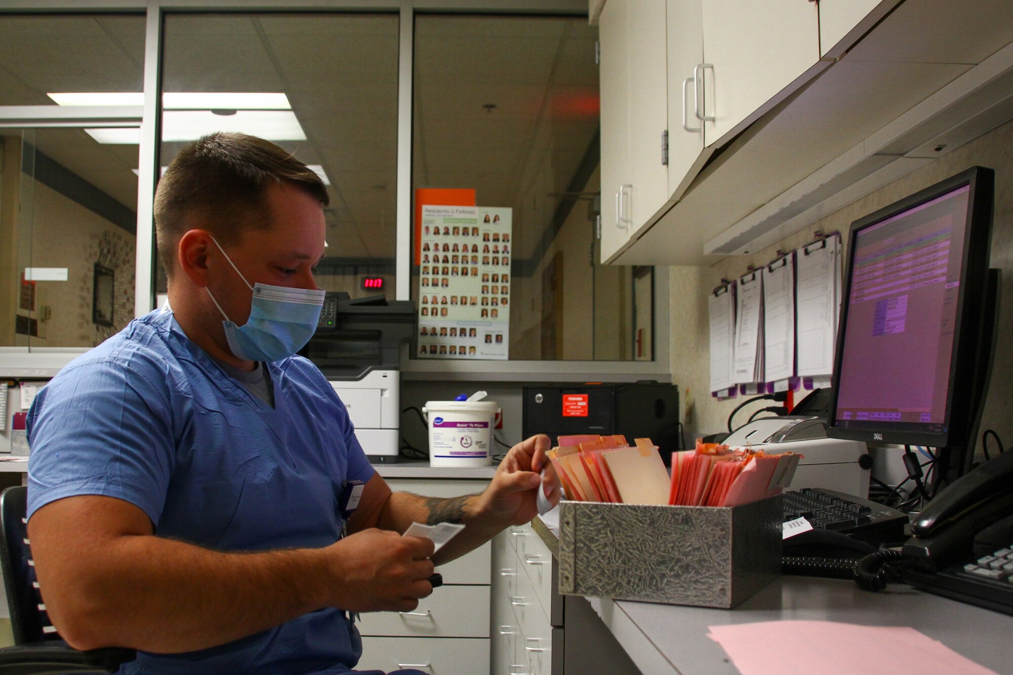 Kentucky Army National Guard Sgt. Alex Kropf, a mechanic with 307th Maintenance Company, receives an order for processing in the laboratory at the Medical Center at Bowling Green Oct. 20, 2021. The Kentucky National Guard is supporting hospitals across the commonwealth.
