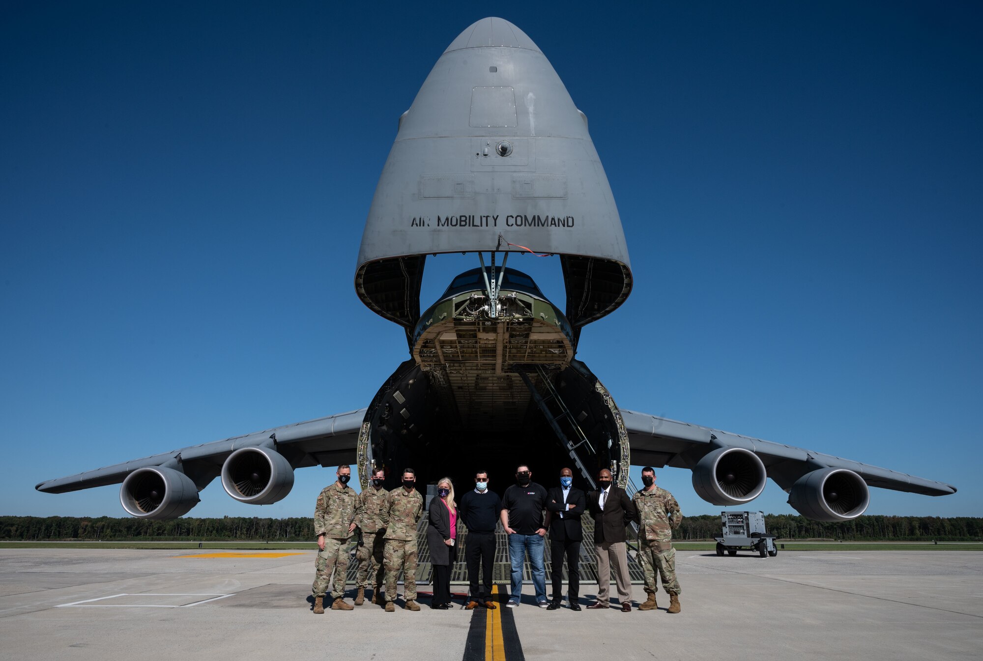 Team Dover Airmen and representatives from the T-Mobile customer discovery team pose for a photo on Dover Air Force Base, Delaware, Oct. 20, 2021. The T-Mobile team met with Dover AFB Airmen to discuss new innovative ways to enhance mission effectiveness and accelerate change in meaningful ways. (U.S. Air Force photo by Senior Airman Marco A. Gomez)