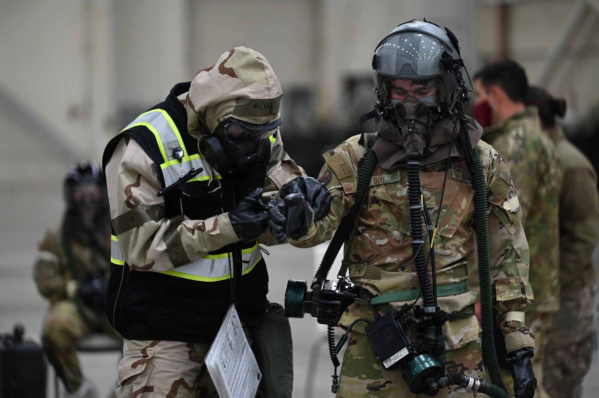 Airmen from the 41st Airlift Squadron go through the decontamination line during an exercise.