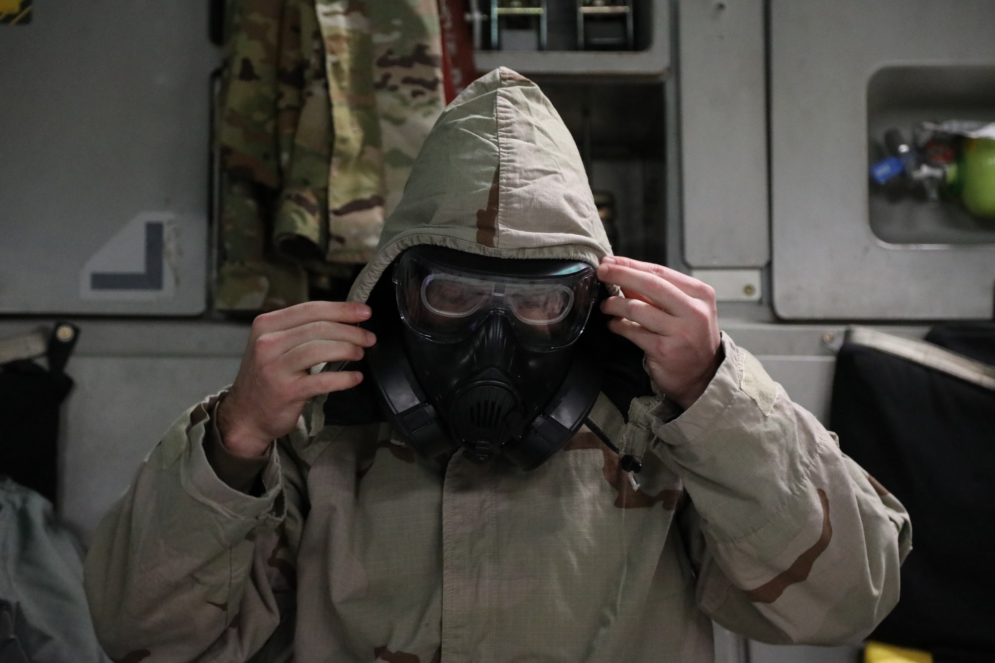 U.S. Air Force Staff Sgt. Jose Chirino, 62nd Aircraft Maintenance Squadron crew chief, dons mission oriented protective posture (MOPP) gear on a C-17 Globemaster III during Exercise Rainier War 21B at Joint Base Lewis-McChord, Washington, Nov. 3, 2021. Rainier War is a semi-annual, large readiness exercise led by 62nd Airlift Wing, designed to train aircrews under realistic scenarios that support a full spectrum readiness operations against modern threats and replicate today’s contingency operations. (U.S. Air Force photo by Senior Airman Christopher Sommers)