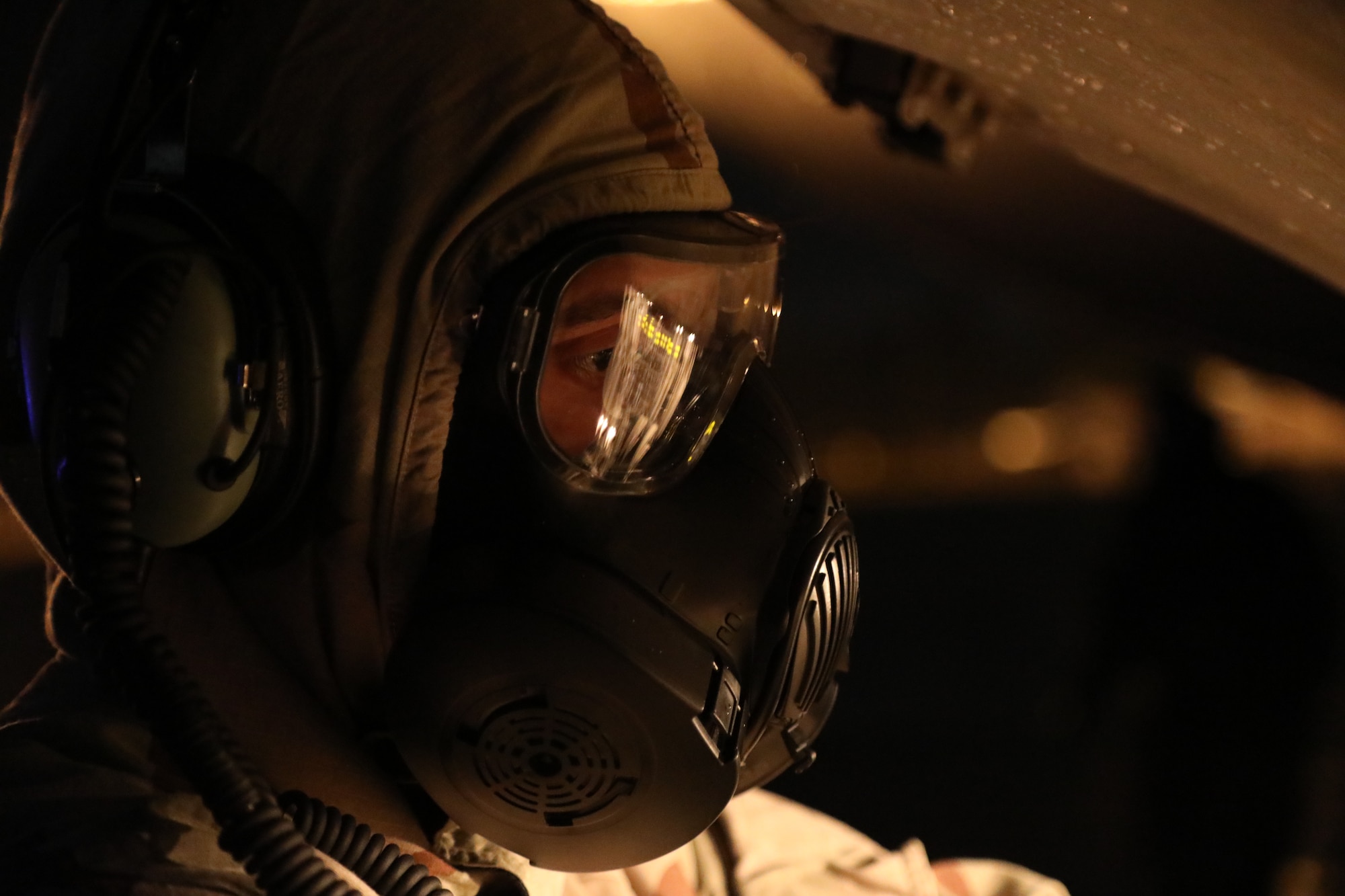 U.S. Air Force Staff Sgt. Jose Chirino, 62nd Aircraft Maintenance Squadron crew chief, prepares a C-17 Globemaster III for refueling while under simulated chemical, biological, radiological and nuclear conditions during Exercise Rainier War 21B at Joint Base Lewis-McChord, Washington, Nov. 3, 2021. Rainier War is a semi-annual, large readiness exercise led by 62nd Airlift Wing, designed to train Airmen under realistic scenarios that support a full spectrum readiness operations against modern threats and replicate today’s contingency operations. (U.S. Air Force photo by Senior Airman Christopher Sommers)