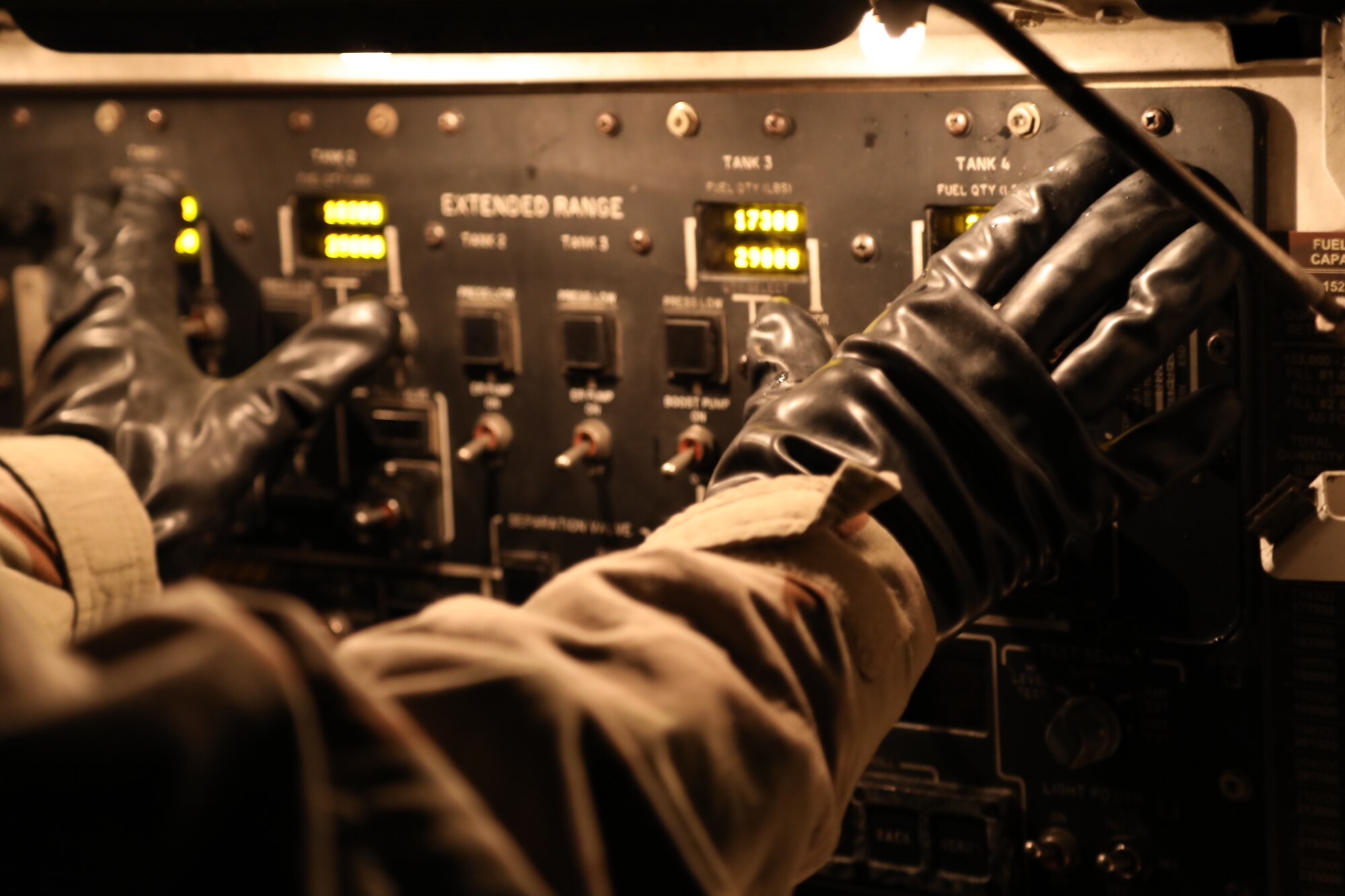 U.S. Air Force Staff Sgt. Jose Chirino, 62nd Aircraft Maintenance Squadron crew chief, prepares a C-17 Globemaster III for refueling while under simulated chemical, biological, radiological and nuclear conditions during Exercise Rainier War 21B at Joint Base Lewis-McChord, Washington, Nov. 3, 2021. Rainier War 21B exercises and evaluates the wing’s ability to employ the force and their ability to perform during wartime and/or contingency taskings in a high-intensity, wartime contested, degraded and operationally limited environment while supporting the contingency operations against a near-peer adversary in the U.S. Indo-Pacific Command area of responsibility. (U.S. Air Force photo by Senior Airman Christopher Sommers)