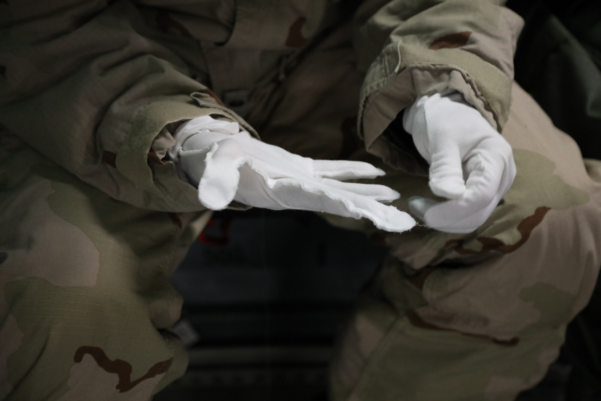 U.S. Air Force Staff Sgt. Jose Chirino, 62nd Aircraft Maintenance Squadron crew chief, dawns Mission Oriented Protective Posture (MOPP) gear on a C-17 Globemaster III during Exercise Rainier War 21B at Joint Base Lewis-McChord, Washington, Nov. 3, 2021. Rainier War 21B exercises and evaluates the wing’s ability to employ the force and their ability to perform during wartime and/or contingency taskings in a high-intensity, wartime contested, degraded and operationally limited environment while supporting the contingency operations against a near-peer adversary in the U.S. Indo-Pacific Command area of responsibility. (U.S. Air Force photo by Senior Airman Christopher Sommers)