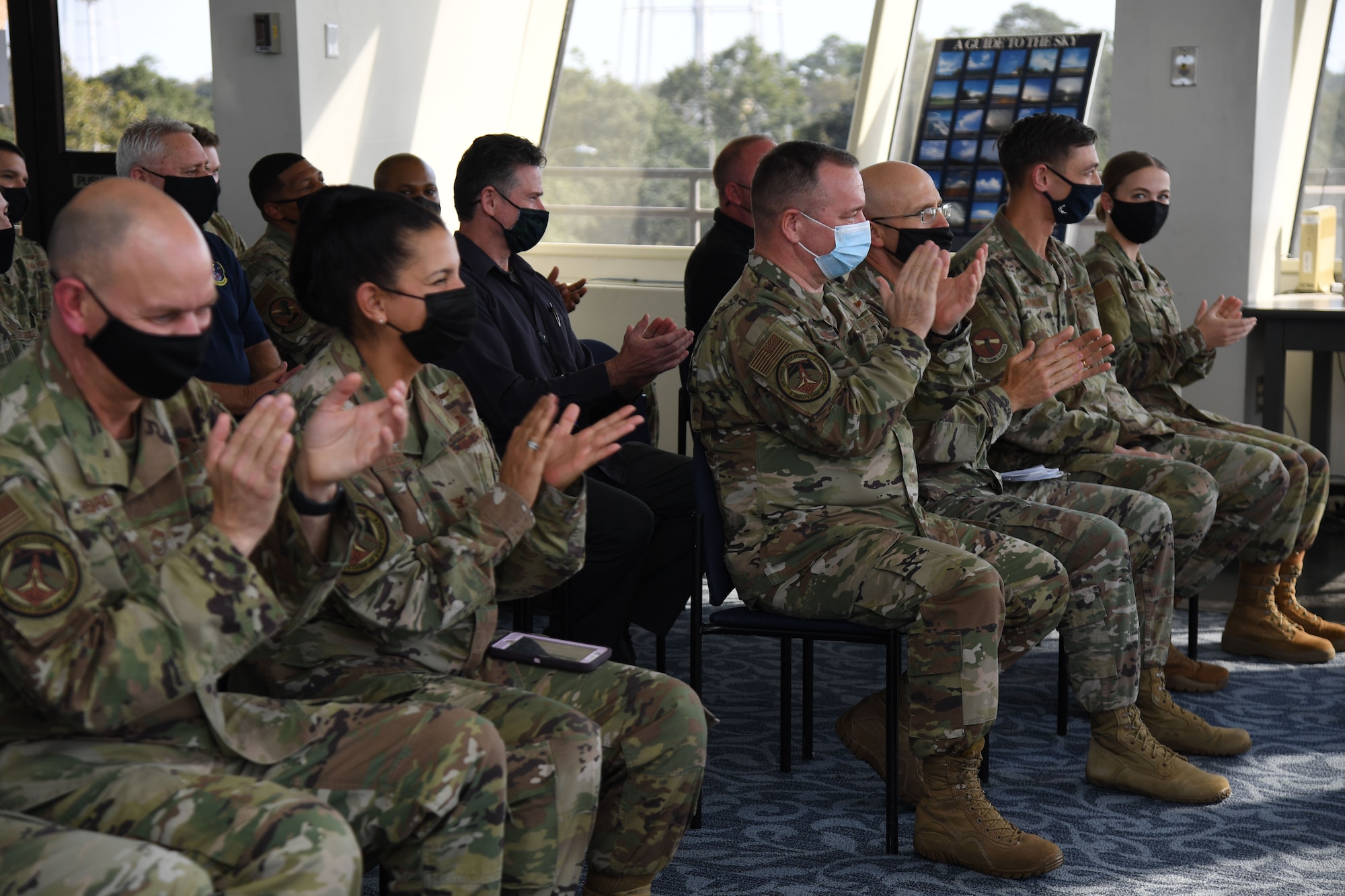 Air Force personnel attend the Space Weather Support Course ribbon cutting ceremony inside the Weather Training Complex at Keesler Air Force Base, Mississippi, Nov. 3, 2021. The course will apply knowledge of the effects of the natural environment on space systems and also space weather effects on terrestrial systems in support of multi-domain operations. (U.S. Air Force photo by Kemberly Groue)