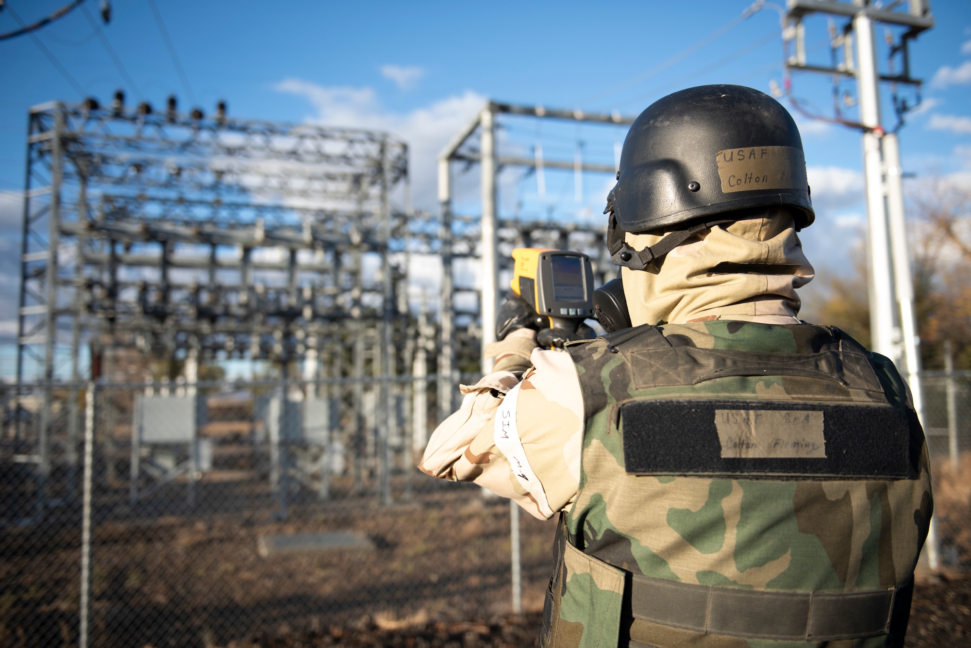 U.S. Air Force Senior Airman Colton Fleming, Electric Systems Journeyman, 366th Civil Engineer Squadron, uses an infrared meter to check for hot spots on insulators during an exercise on Mountain Home Air Force Base, Idaho, Oct. 27, 2021. Mission generation during this exercise is essential to see how we would continue to operate in a contested chemical environment.