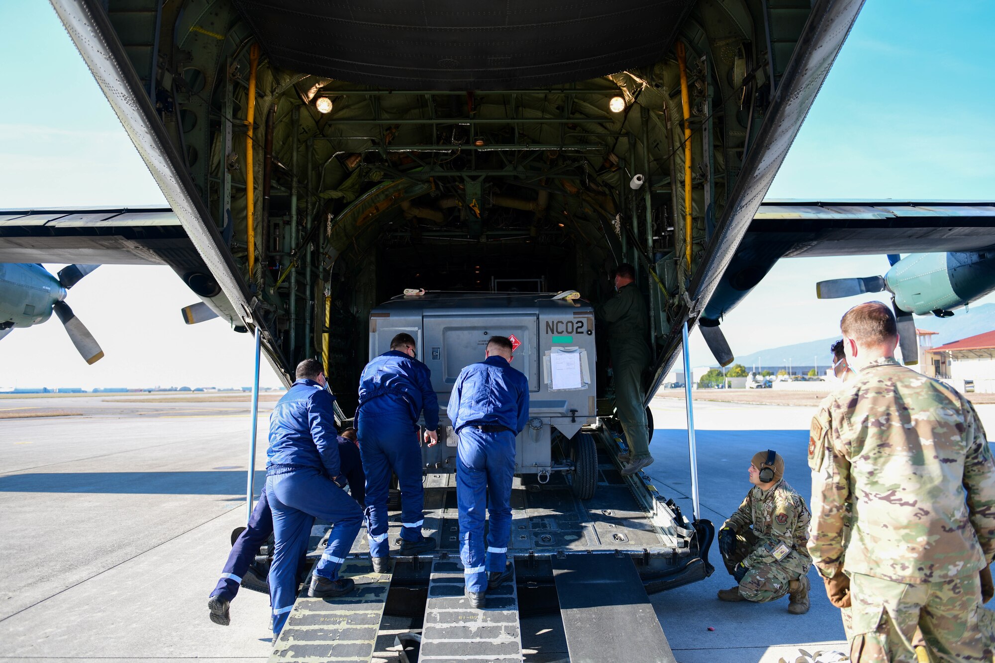 Romanian air force airmen and U.S. Air Force Airmen assigned to the 31st Logistics Readiness Squadron load a cart onto a Romanian air force C-130 at Aviano Air Base, Italy, Oct. 29, 2021. The C-130 was loaded with critical cargo for U.S. Air Force F-16C Fighting Falcons assigned to the 31st Fighter Wing participating in an exercise as part of operation Castle Forge at Campia Turzii, Romania. Operation Castle Forge is U.S. Air Forces in Europe and Air Forces Africa’s premiere theater-wide Agile Combat Employment exercise, focused on shifting forces and the way they operate in a dynamic theater. (U.S. Air Force photo by Senior Airman Brooke Moeder)
