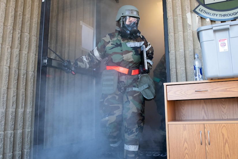 U.S. Air Force Staff Sgt. Karin Mayville, 366th Munitions Squadron Unit Command and Control lead, evacuates a simulated demolished building during a Phase II exercise on Mountain Home Air Force Base, Idaho, Oct. 26, 2021. The purpose of Phase II training exercises is to test service members’ ability to survive and operate in a contested environment.