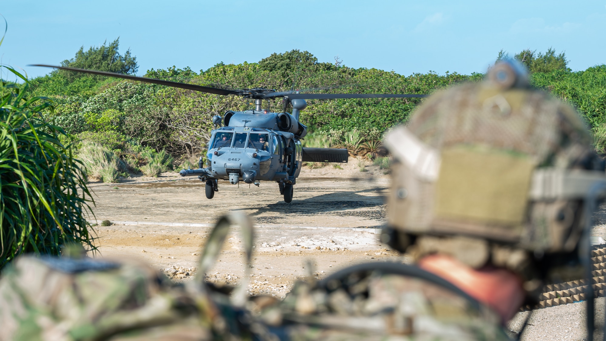 A combat controller observes a helicopter.