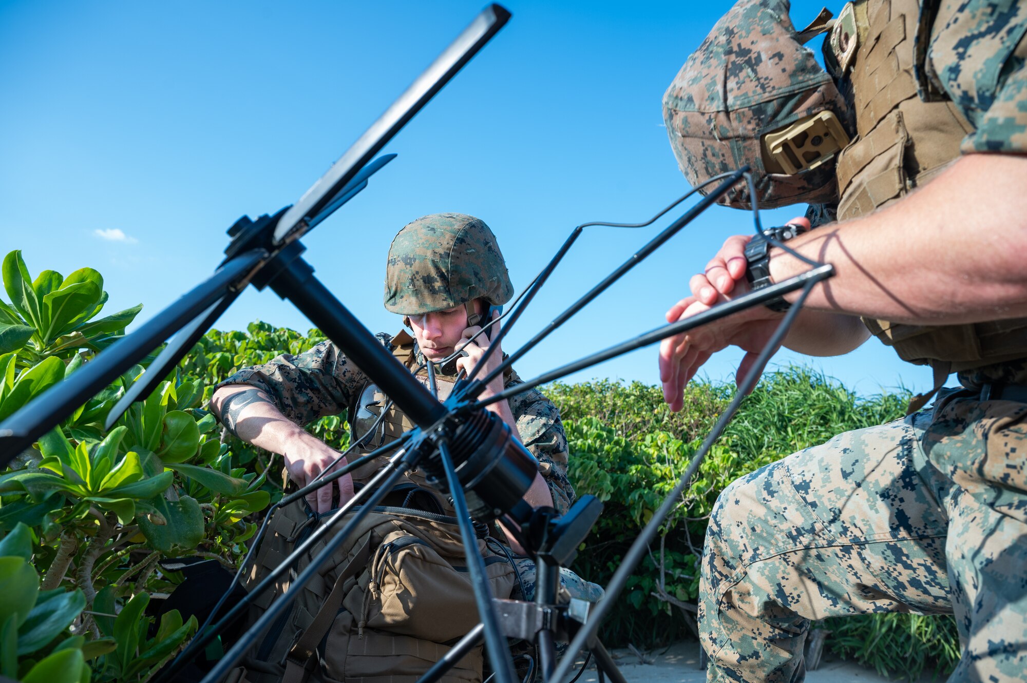 Marines communicate on a radio.