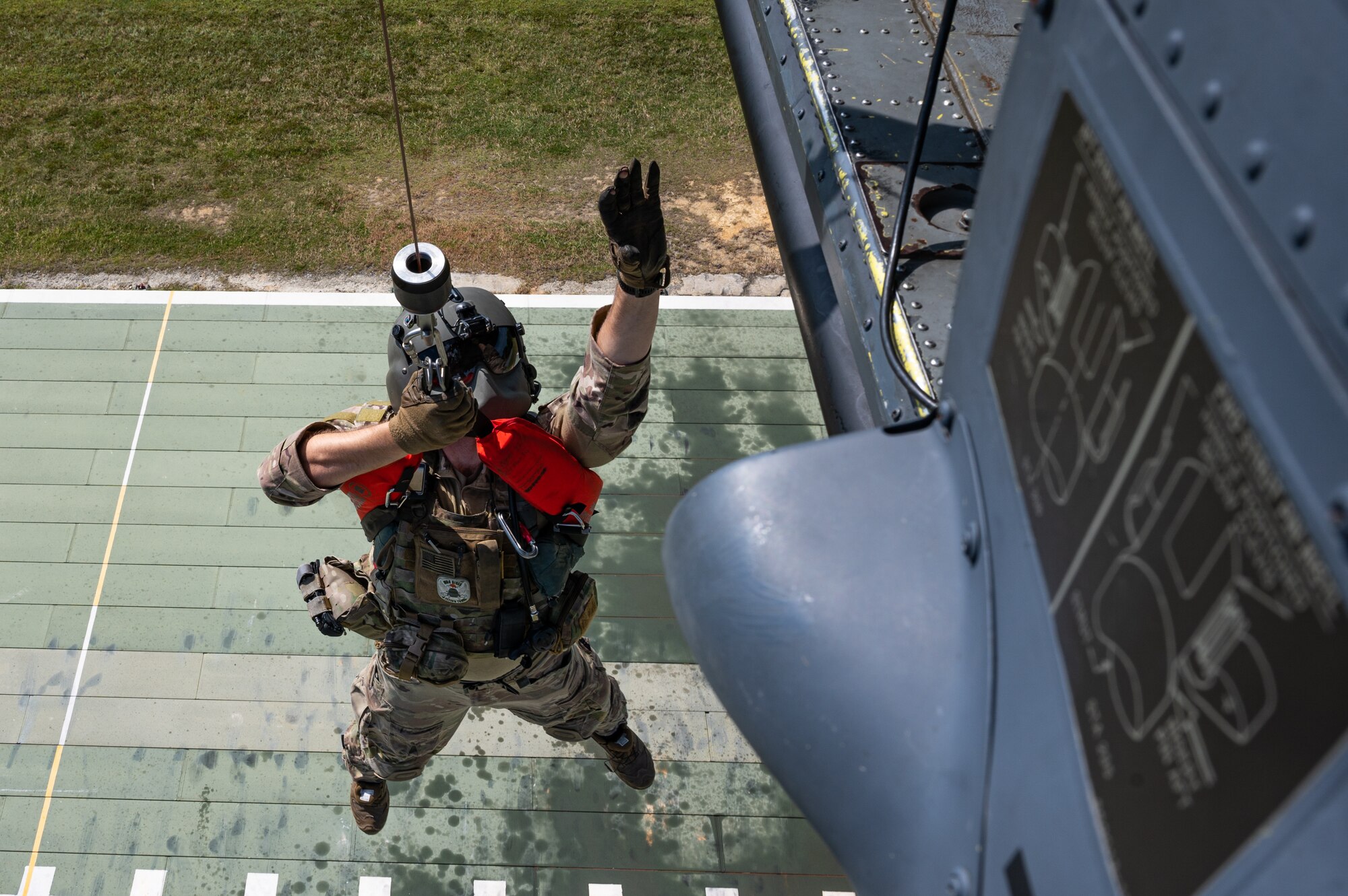 An airman hoists on a helicopter.