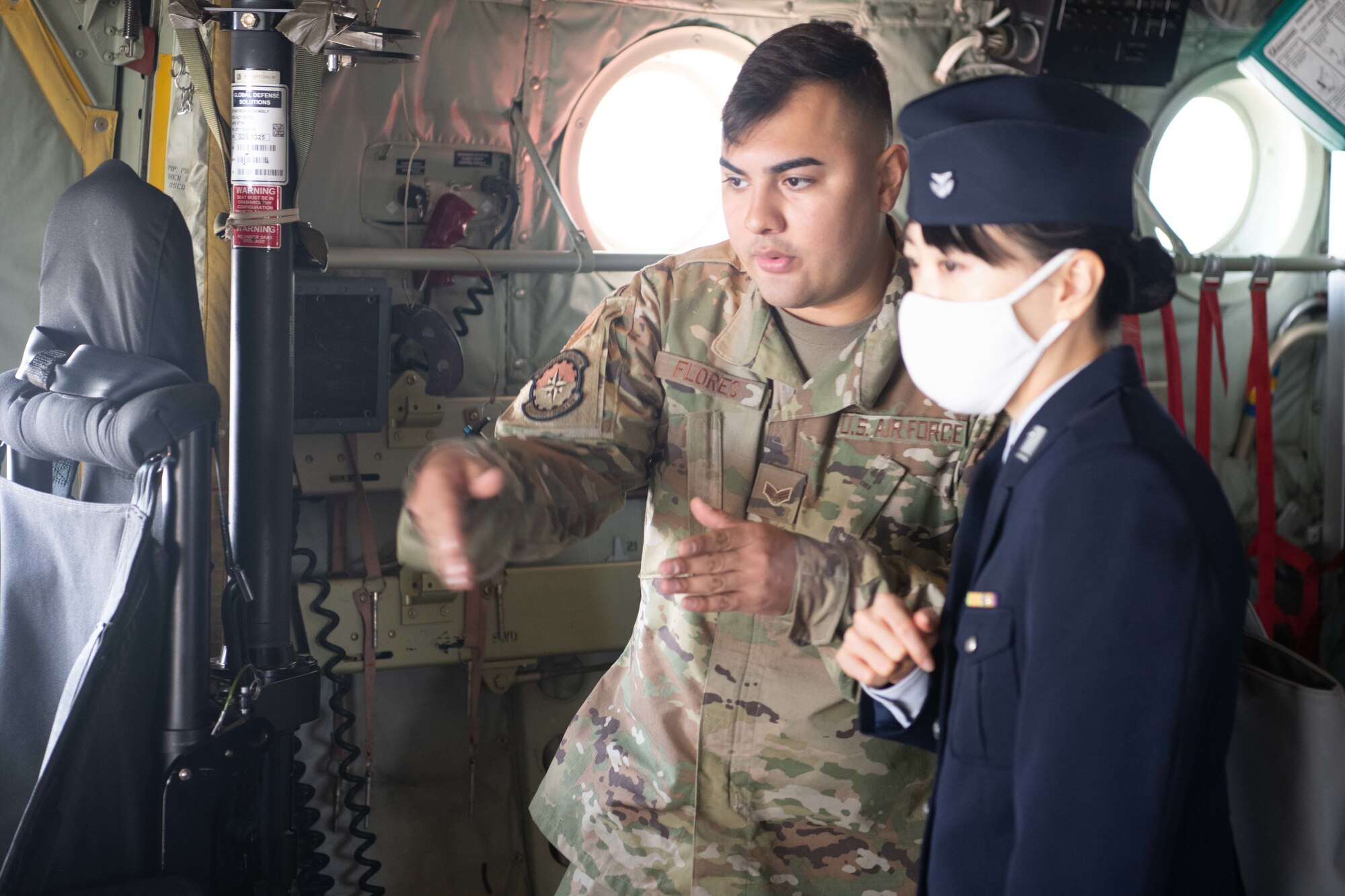 U.S. Air Force Senior Airman Cristian Flores, 374th Aircraft Maintenance Squadron C-130J crew chief, left, briefs Koku-Jieitai (Japan Air Self-Defense Force) Staff Sgt. Satomi Mukai, 401st Tactical Airlift Squadron maintenance, supply, and headquarters specialist