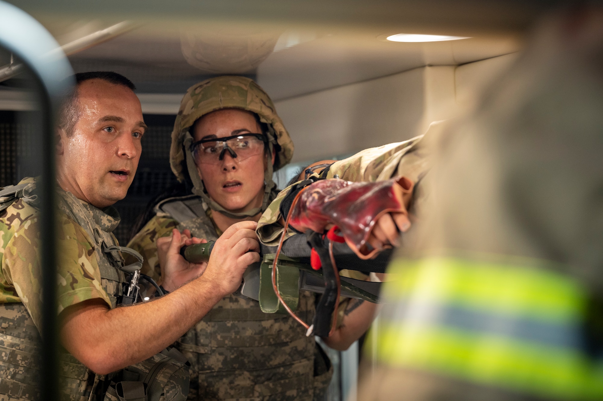 Photo of U.S. Air Force first responders load a simulated casualty into an ambulance.