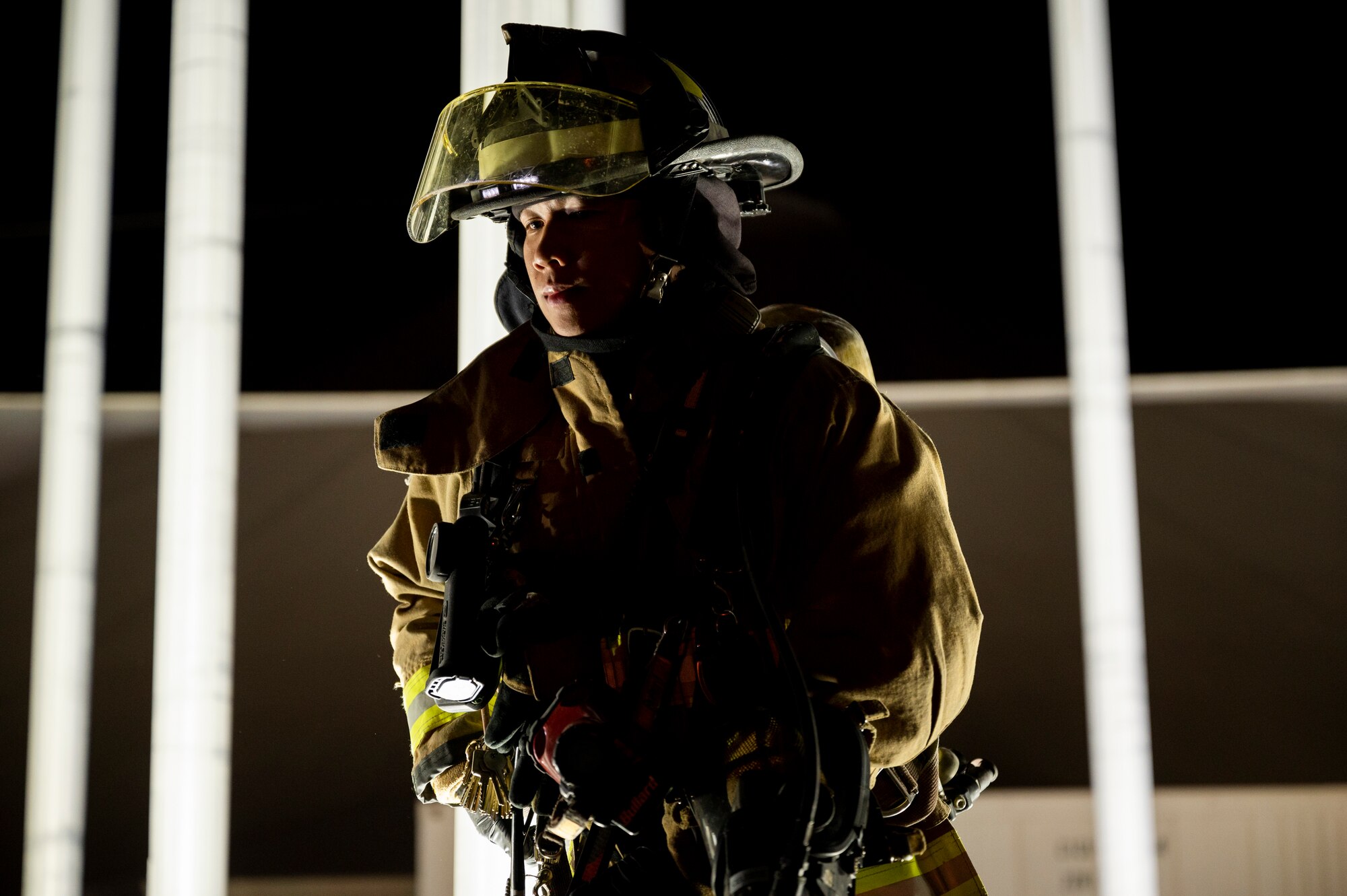 Photo of a U.S. Air Force firefighter during the dark.
