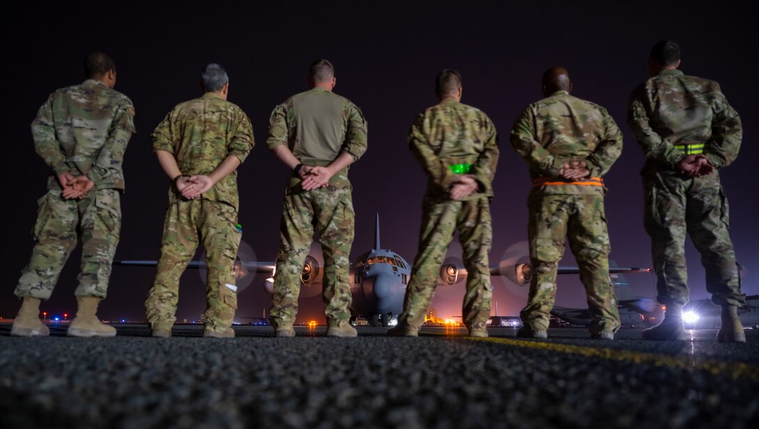 Members from the 779th Expeditionary Airlift Squadron wait for personnel to depart a C-130H Hercules at Ali Al Salem Air Base, Kuwait, Nov. 2, 2021.