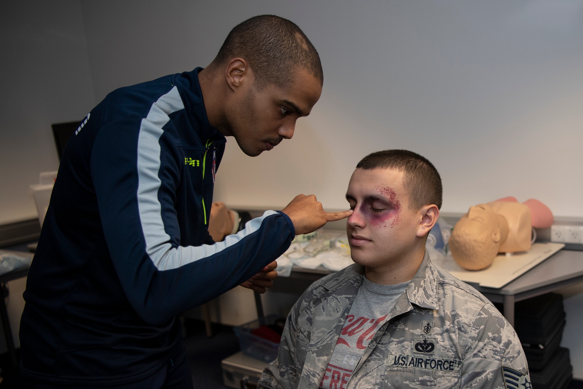 U.S. Air Force Staff Sgt. Nelson Pacheco, 52nd Medical Group public health technician, applies moulage to a simulated wounded victim’s face during exercise Sabre Storm, Nov. 3, 2021, on Spangdahlem Air Base, Germany. The moulage simulated injuries, enabling the 52nd MDG to put their readiness to the test. (U.S. Air Force photo by Staff Sgt. Melody W. Howley)